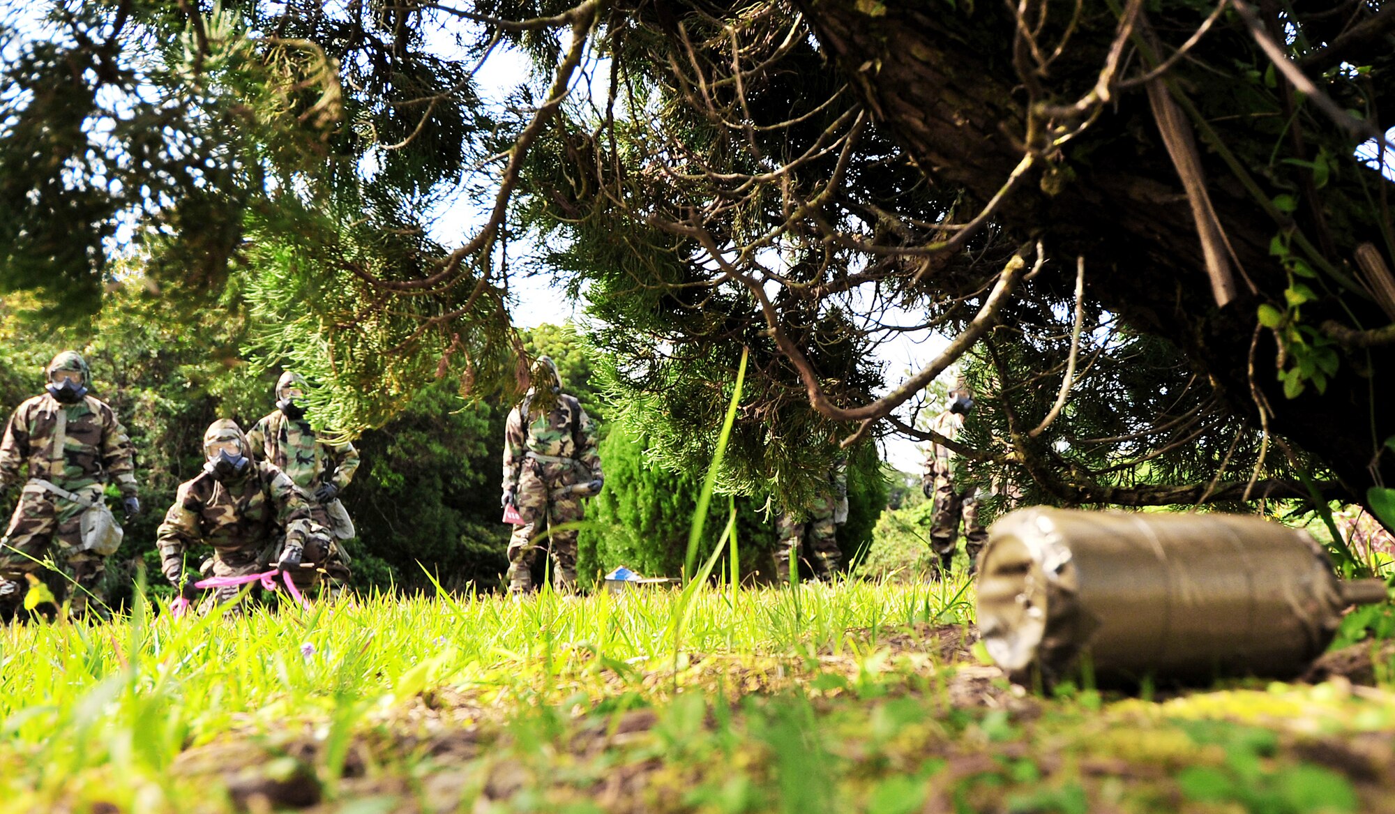 A group of Airmen from the 18th Munitions Squadron locate an unidentified explosive ordnance during an "Ability to Survive and Operate" course Feb. 24, 2010, at Kadena Air Base, Japan. The 18th MUNS held the course for more than 200 Airmen to hone their skills and learn how to perform their trade in a hostile environment. (U.S. Air Force photo/Tech. Sgt. Rey Ramon)