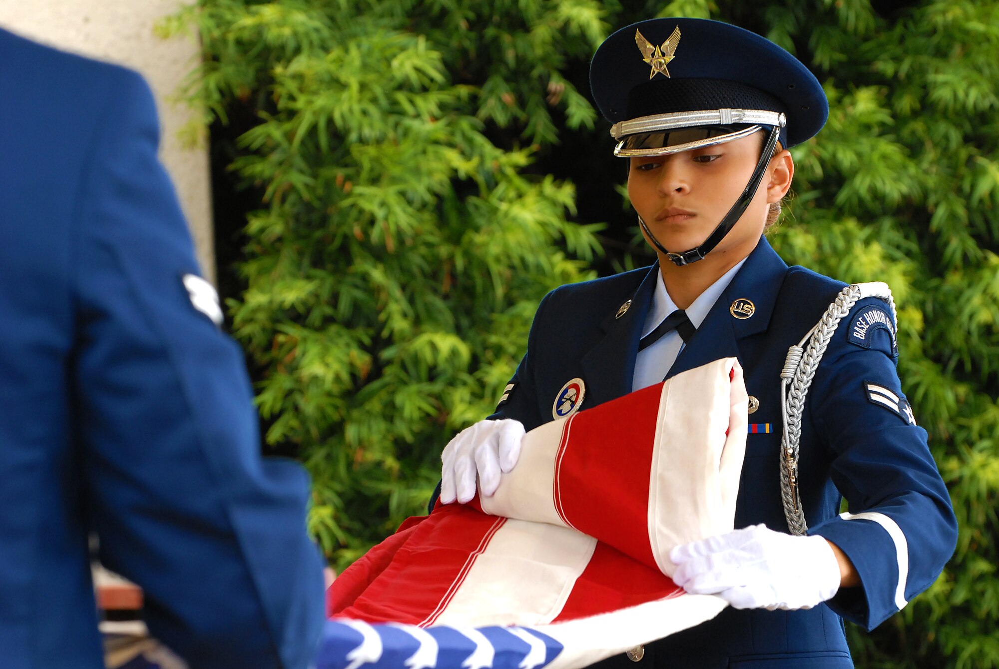 HONOLULU -- Airman 1st Class Stephany Sanchez, 15th Airlift Wing Honor Guard, folds the American Flag for family members of a veteran's funeral ceremony at the National Memorial Cemetery of the Pacific March 3. The Hickam Honor Guard has the responsibility of representing the United States Air Force throughout the Hawaiian Islands as friends and family gather to pay their final respects to their loved ones that have honorably served their country.(U.S. Air Force photo/Staff Sgt. Mike Meares)