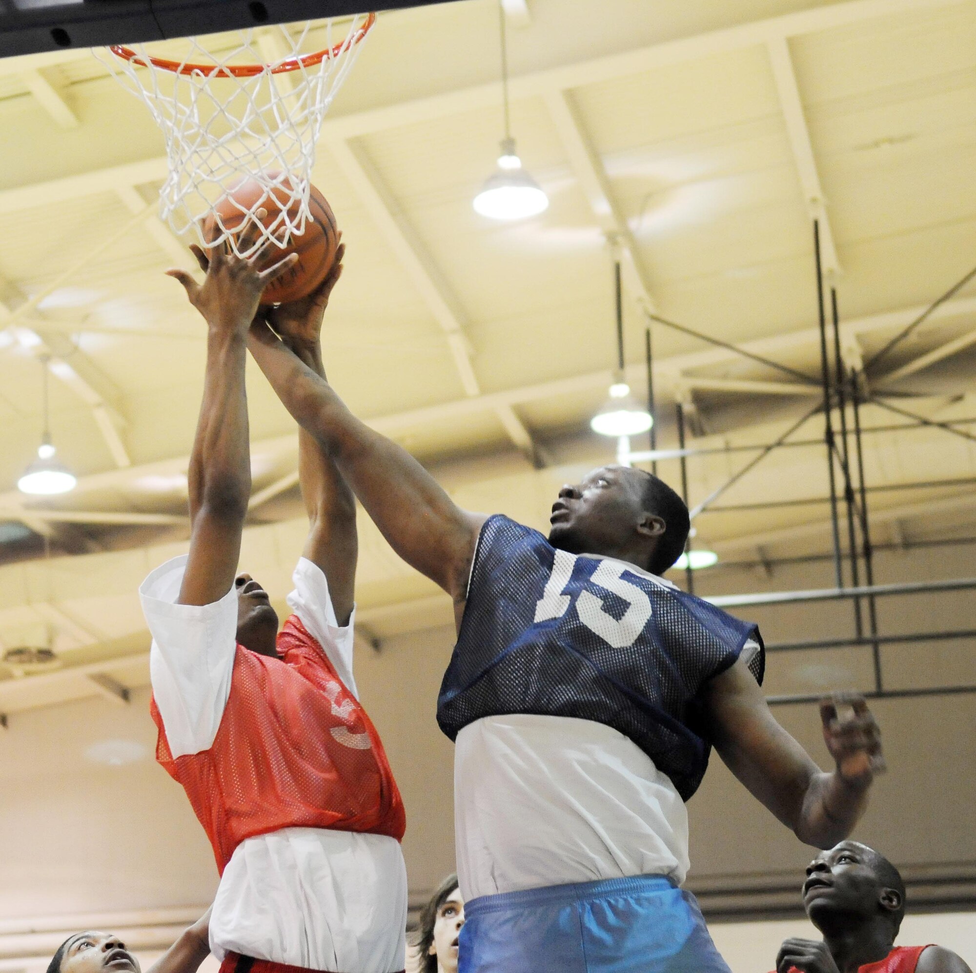 Senior Airman Anthony Grant reaches for a rebound against an opponent March 3, 2010, Eielson Air Force Base. The Civil Engineer Squadron won against the Force Support Squadron. Airman Grant is assigned to 354th CES. (U.S. Air Force photo by/Airman 1st Class Janine Thibault)
