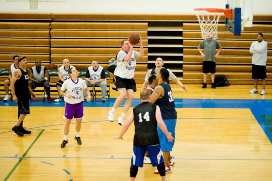 JOINT BASE LEWIS-MCCHORD, Wash.- 446th Airlift Wing Warrior forward Lane Seaholm attempts a shot late in the second half of the 30-and-over league's semi-final playoff loss versus the 62nd Maintenance Squadron Maintainers, 49-65, at the JBLM Fitness Center, March 9. The Maintainers snapped the Warriors 12-game win streak. (U.S. Air Force photo/Abner Guzman)