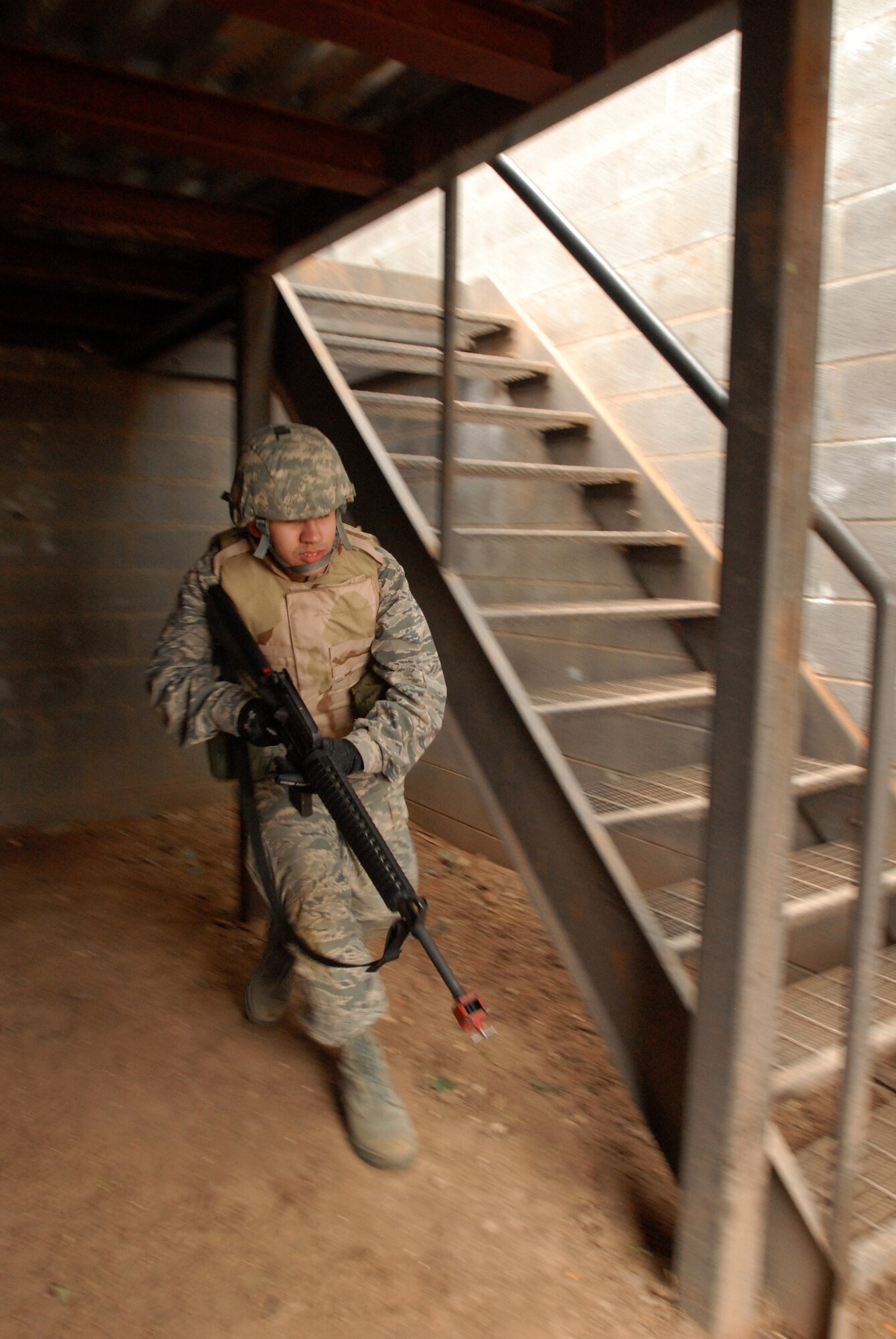 GOODFELLOW AIR FORCE BASE, Texas - Cadet Jonathan Van Noord, a member of the Air Force Reserve Officer Training Corps Detachment 847, Angelo State University, San Angelo, Texas, moves out of a cleared building while his unit clears a village looking for a capture American, March 6, 2010.  The 17th Training Wing hosted cadets for 2 days during which cadets participated in class room instruction, field training and a deployment exercise at Goodfellow’s Forward Operating Base Sentinel. (U.S. Air Force photo/Master Sgt Randy Mallard)