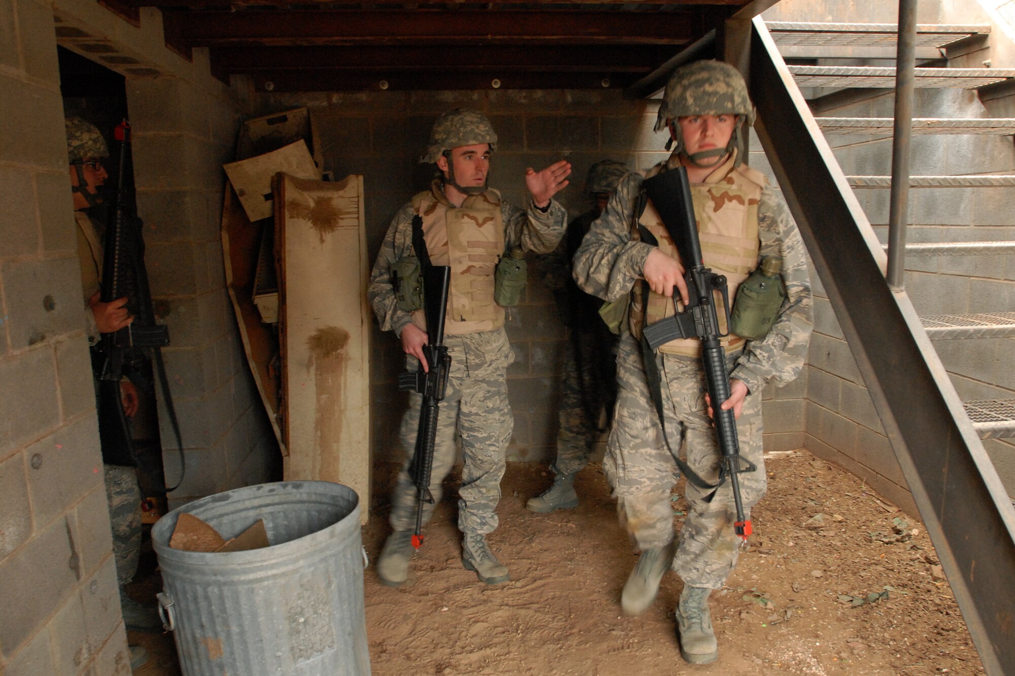 GOODFELLOW AIR FORCE BASE, Texas - Cadet Jonathan Avera, a member of the Air Force Reserve Officer Training Corps Detachment 847, Angelo State University, San Angelo, Texas, gives orders as his unit prepares to clear a village looking for a capture American, March 6, 2010.  The 17th Training Wing hosted cadets for 2 days during which cadets participated in class room instruction, field training and a deployment exercise at Goodfellow’s Forward Operating Base Sentinel. (U.S. Air Force photo/Master Sgt Randy Mallard)

