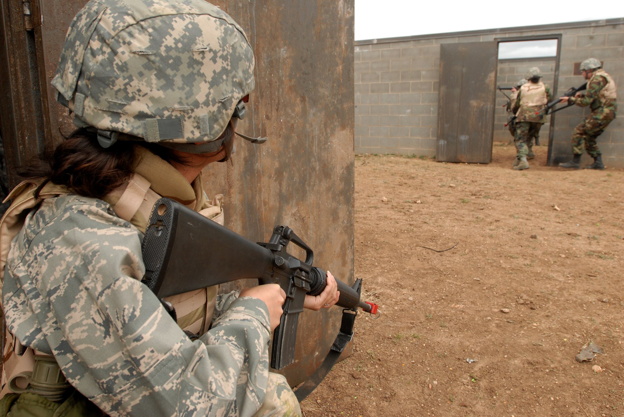 GOODFELLOW AIR FORCE BASE, Texas - Cadet Mayra Gomez, a member of the Air Force Reserve Officer Training Corps Detachment 847, Angelo State University, San Angelo, Texas, provides security for her unit as they clear a village looking for a capture American, March 6, 2010.  The 17th Training Wing hosted cadets for 2 days during which cadets participated in class room instruction, field training and a deployment exercise at Goodfellow’s Forward Operating Base Sentinel. (U.S. Air Force photo/Master Sgt Randy Mallard)