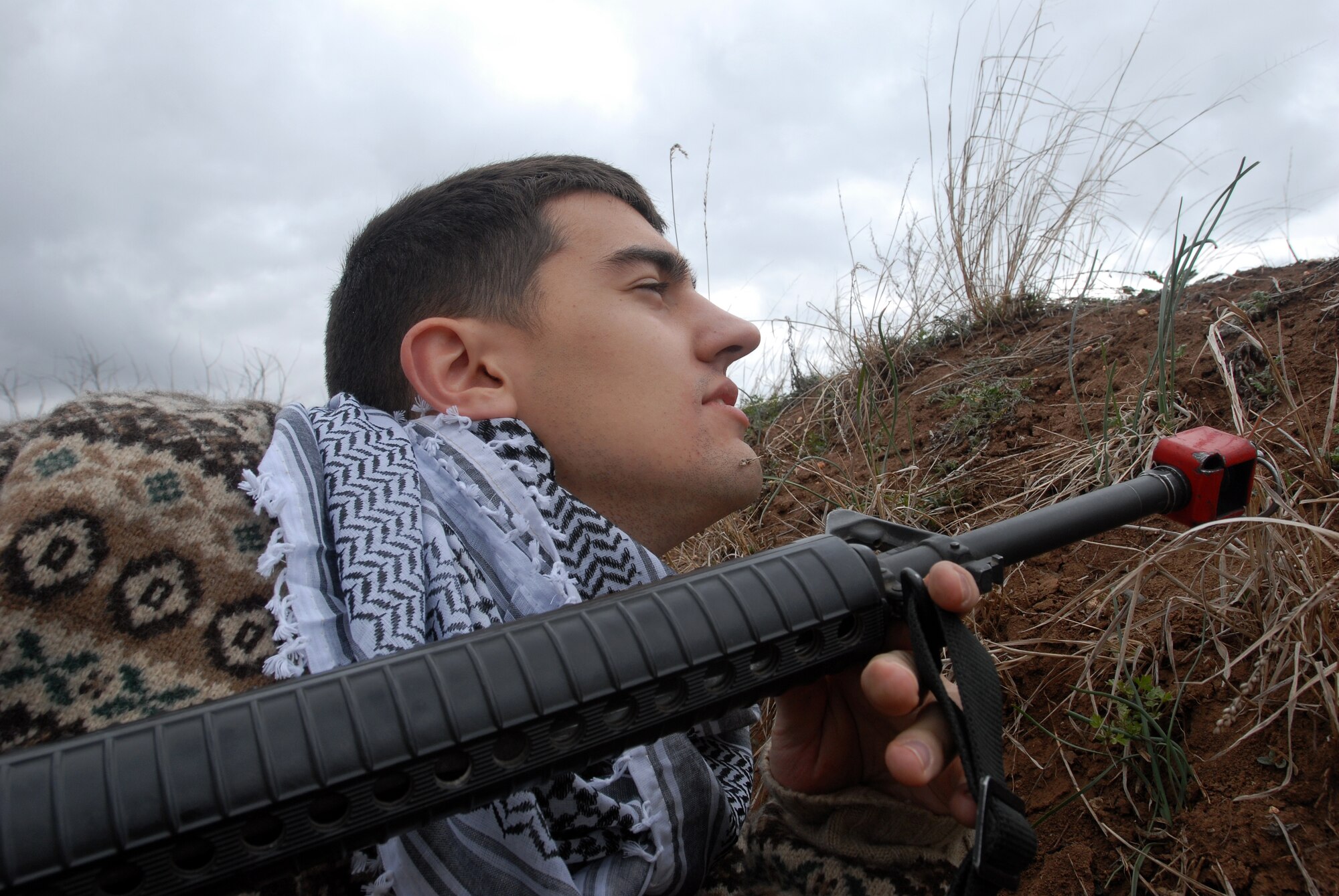 GOODFELLOW AIR FORCE BASE, Texas - Senior Airman Bryan Woods, 316th Training Squadron, Goodfellow AFB, Texas, playing the part of the opposing force, waits to ambush a patrol during a training exercise with cadets from Air Force Reserve Officer Training Corps Detachment 847, Angelo State University, San Angelo, Texas, March 6, 2010. The 17th Training Wing hosted cadets for 2 days during which cadets participated in class room instruction, field training and a deployment exercise at Goodfellow’s Forward Operating Base Sentinel. (U.S. Air Force photo/Master Sgt Randy Mallard)