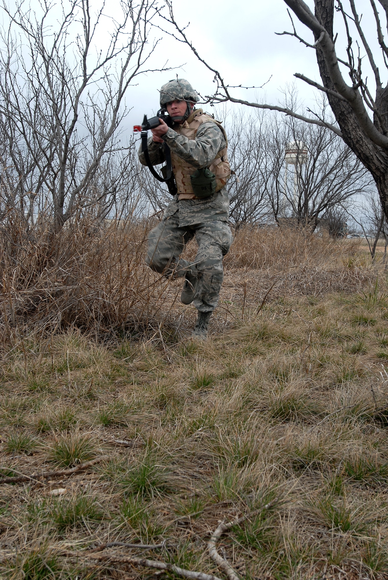 GOODFELLOW AIR FORCE BASE, Texas - Cadet Perry Byrd, a member of the Air Force Reserve Officer Training Corps Detachment 847, Angelo State University, San Angelo, Texas, pushes through a simulated ambush as his unit practices reacting to hostile fire prior to an actual field exercise, March 6, 2010.  The 17th Training Wing hosted cadets for 2 days during which cadets participated in class room instruction, field training and a deployment exercise at Goodfellow’s Forward Operating Base Sentinel. (U.S. Air Force photo/Master Sgt Randy Mallard)