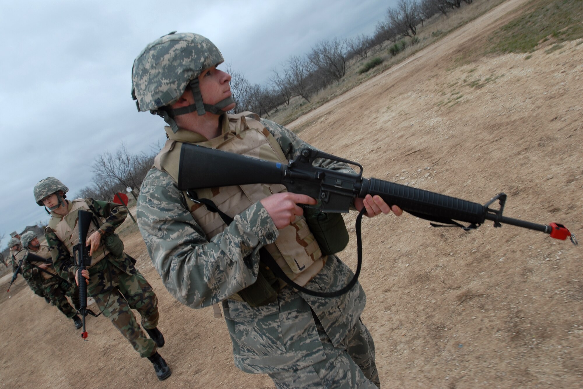 GOODFELLOW AIR FORCE BASE, Texas - Cadet Perry Byrd, a member of the Air Force Reserve Officer Training Corps Detachment 847, Angelo State University, San Angelo, Texas, keeps watch for potential threats as his unit practices reacting to hostile fire prior to an actual field exercise, March 6, 2010.  The 17th Training Wing hosted cadets for 2 days during which cadets participated in class room instruction, field training and a deployment exercise at Goodfellow’s Forward Operating Base Sentinel. (U.S. Air Force photo/Master Sgt Randy Mallard)