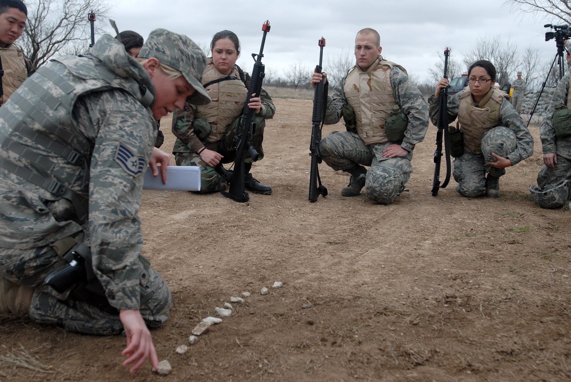 GOODFELLOW AIR FORCE BASE, Texas - Staff Sgt. DeAndra Vertrees, a member of the 17th Security Forces Squadron, Goodfellow, AFB, Texas, use the rock drill method to instruct cadets from Air Force Reserve Officer Training Corps Detachment 847, Angelo State University, San Angelo, Texas, on how to react to hostile fire prior to an actual field exercise, March 6, 2010. The 17th Training Wing hosted cadets for 2 days during which cadets participated in class room instruction, field training and a deployment exercise at Goodfellow AFB’s Forward Operating Base Sentinel. (U.S. Air Force photo/Master Sgt Randy Mallard)