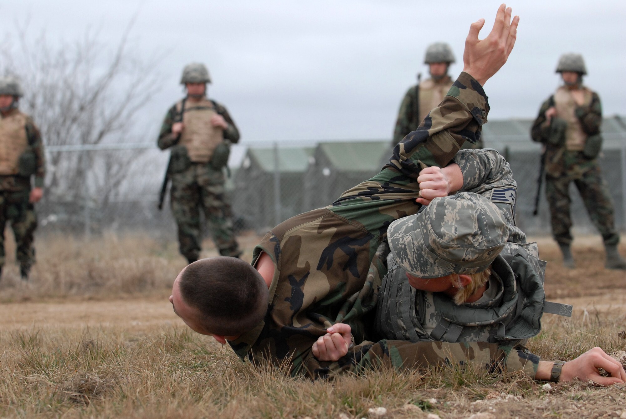 GOODFELLOW AIR FORCE BASE, Texas - Staff Sgt. DeAndra Vertrees, a member of the 17th Security Forces Squadron, Goodfellow, AFB, Texas, demonstrates to cadets, from Air Force Reserve Officer Training Corps Detachment 847, Angelo State University, San Angelo, Texas, the proper technique to roll a body in order to check for hidden threats, March 6, 2010. The 17th Training Wing hosted cadets for 2 days during which cadets participated in class room instruction, field training and a deployment exercise at Goodfellow’s Forward Operating Base Sentinel. (U.S. Air Force photo/Master Sgt Randy Mallard)