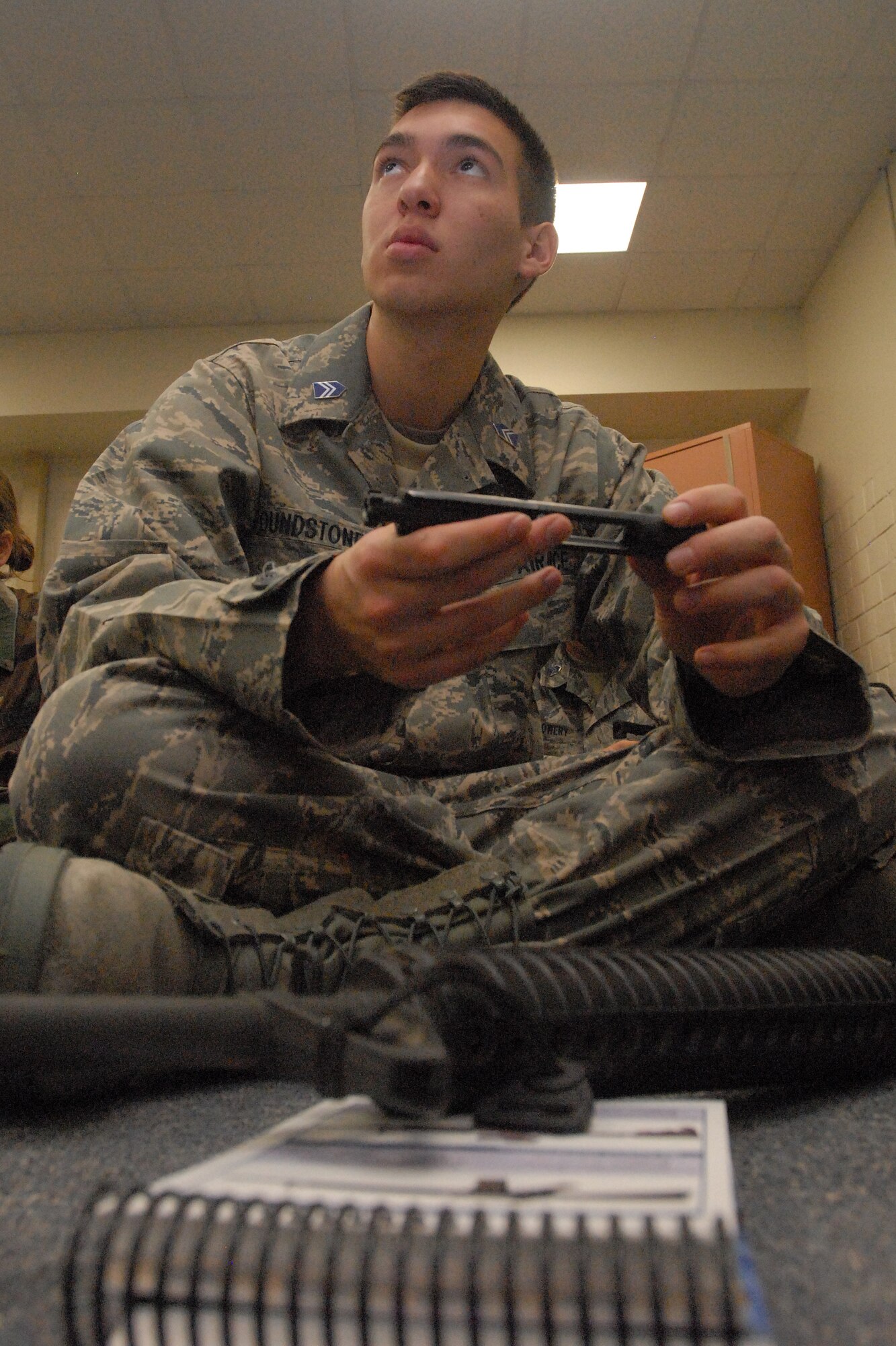 GOODFELLOW AIR FORCE BASE, Texas - Cadet Phillip Poundstone, a member of the Air Force Reserve Officer Training Corps Detachment 847, Angelo State University, San Angelo, Texas, pays attention to instruction on disassembling the bolt carrier of a M16A2 during a weapons familiarization class at Goodfellow AFB, Texas, March 6, 2010.  The 17th Training Wing hosted cadets from Detachment 847 for 2 days during which cadets participated in class room instruction, field training and a deployment exercise at Goodfellow’s Forward Operating Base Sentinel. (U.S. Air Force photo/Master Sgt Randy Mallard)