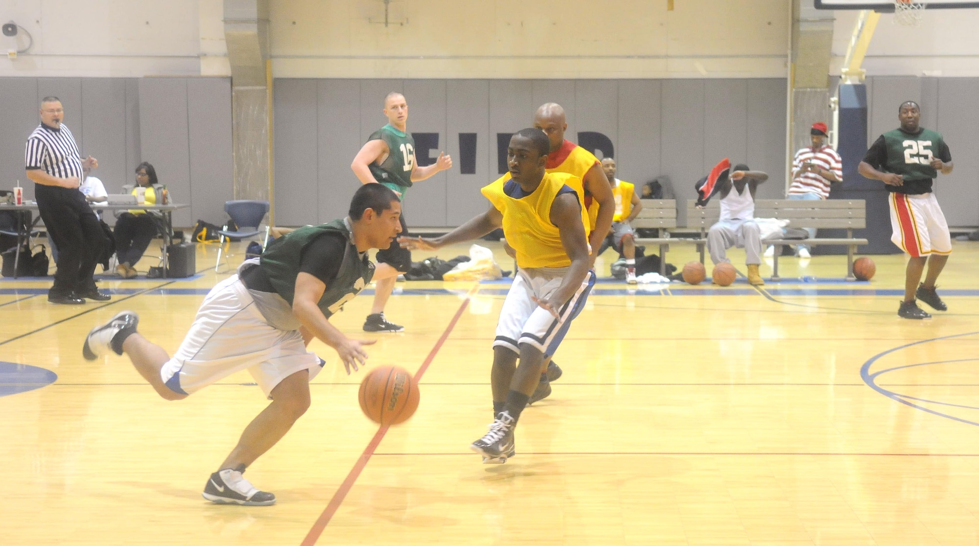 Senior Airman Jake Guevara dribbles past Airman 1st Class Jarrett Myles during a basketball game March 4, 2010, Eielson Air Force Base, Alaska. The Logistics Readiness Squadron won the game against Civil Engineer Squadron. (U.S. Air Force photo by/Airman 1st Class Janine Thibault)