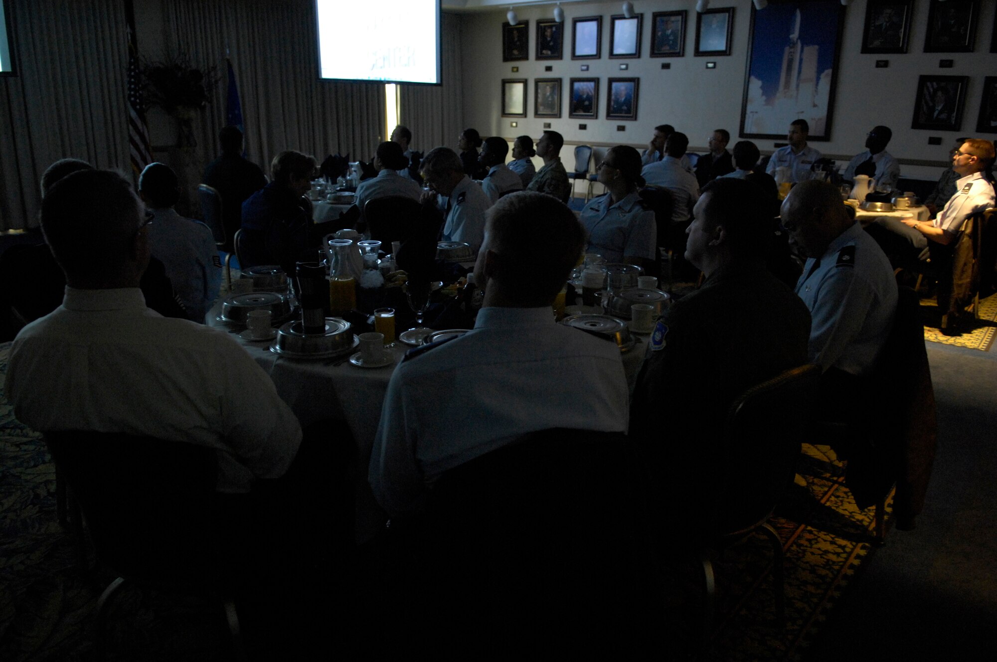 VANDENBERG AIR FORCE BASE, Calif.-- Airmen at the Pacific Coast Club watch an Air Force Assistance Fund campaign presentation before enjoying a hearty breakfast here Monday, March 8, 2010. During the breakfast Team V's AFAF officials were informed about the campaign, which supports Air Force active duty, Guard, Reserve and retired members.  (U.S. Air Force photo/Airman 1st Class Lael Huss)