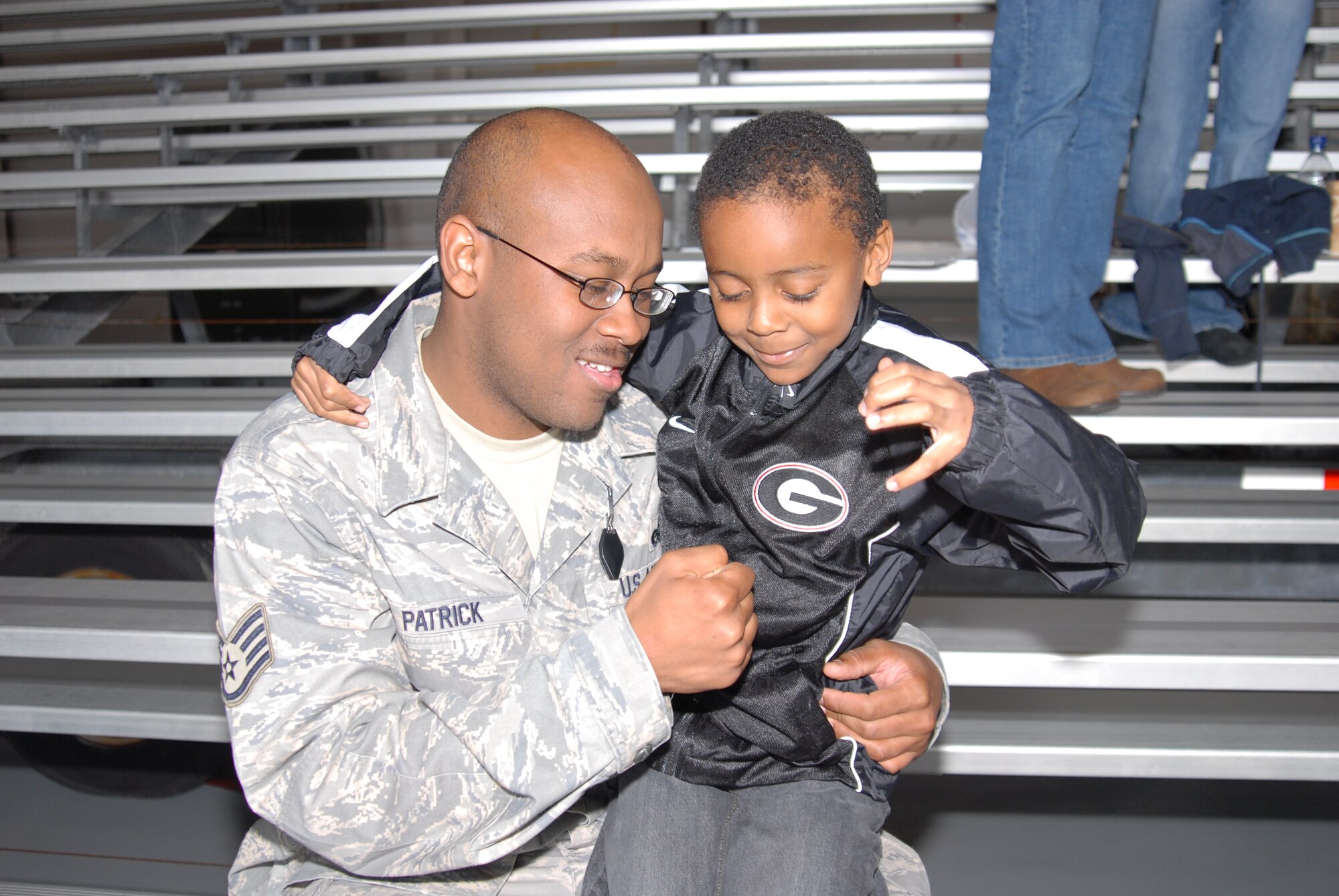 U. S. Air Force Staff Sgt. Andre Patrick, 1st Special Operations Aircraft Maintenance Squadron, has a special moment with his son, Cannon during the Hurlburt Field's Operation Homecoming Ceremony, Hurlburt Field, Fla, Mar. 9, 2010.  Sergeant Patrick and other Airmen assigned to Hurlburt Field are redeploying from various locations in Southwest Asia. (U. S. Air Force photo by Staff Sgt. Orly N. Tyrell/RELEASED)