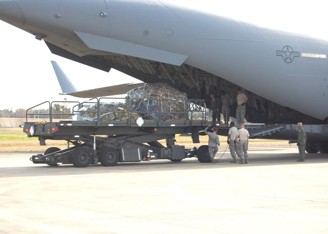 (Photo by Steve Pivnick)
Members of the 81st Logistics Readiness Squadron and C-17 crewmembers load the deploying 81st Medical Group team's baggage March 7 as the team waits to board the aircraft from from the 437th Airlift Wing at Charleston AFB, S.C., that was to transport them to San Antonio  where they were to join members of Lackland AFB’s 59th Medical Wing and 57th MDG before making the final leg of the trip to Chile.