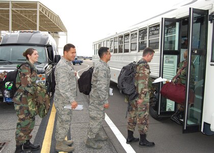 (Photo by Steve Pivnick)
Members of the 81st Medical Group team deploying to Chile board a bus outside Keesler AFB base operations March 7 to be taken to the C-17 “Globemaster III” aircraft from the 437th Airlift Wing at Charleston AFB, S.C., that was to transport them to San Antonio en route to Chile.