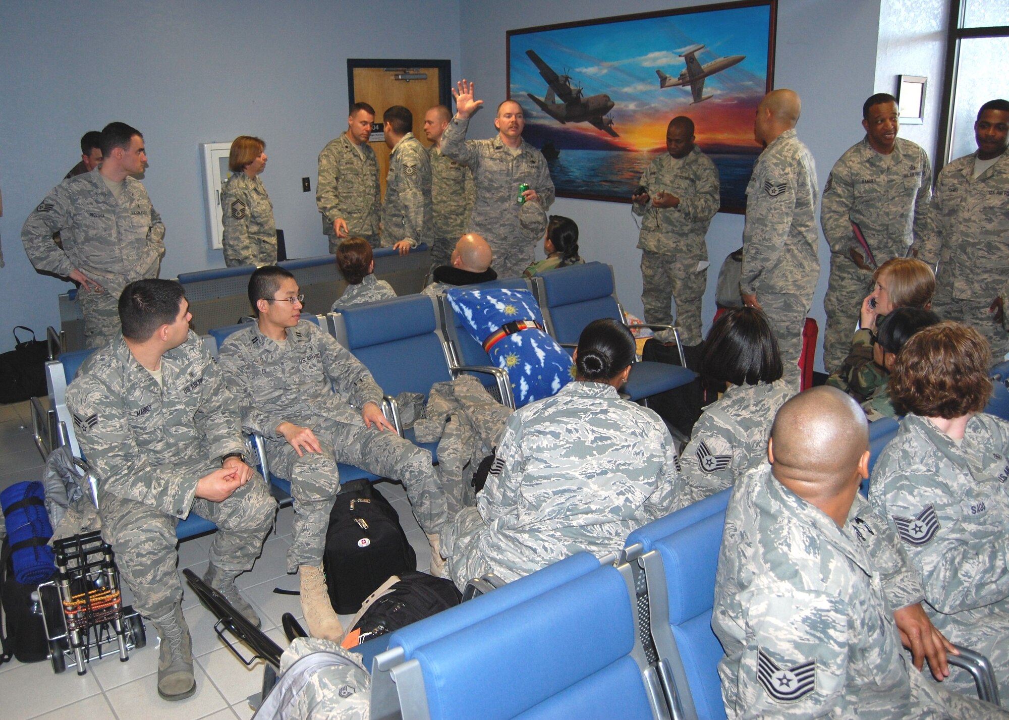 (Photo by Steve Pivnick)
Master Sgt. Shane Fountain, center with hand raised, 81st Medical Support Squadron Readiness Flight, gets the attention of the 81st Medical Group medical team to brief them in Keesler AFB’s base operations March 7.  The “Dragon Medics” were awaiting the arrival of the C-17 “Globemaster III” transport aircraft that was to take them to San Antonio en route to Chile.