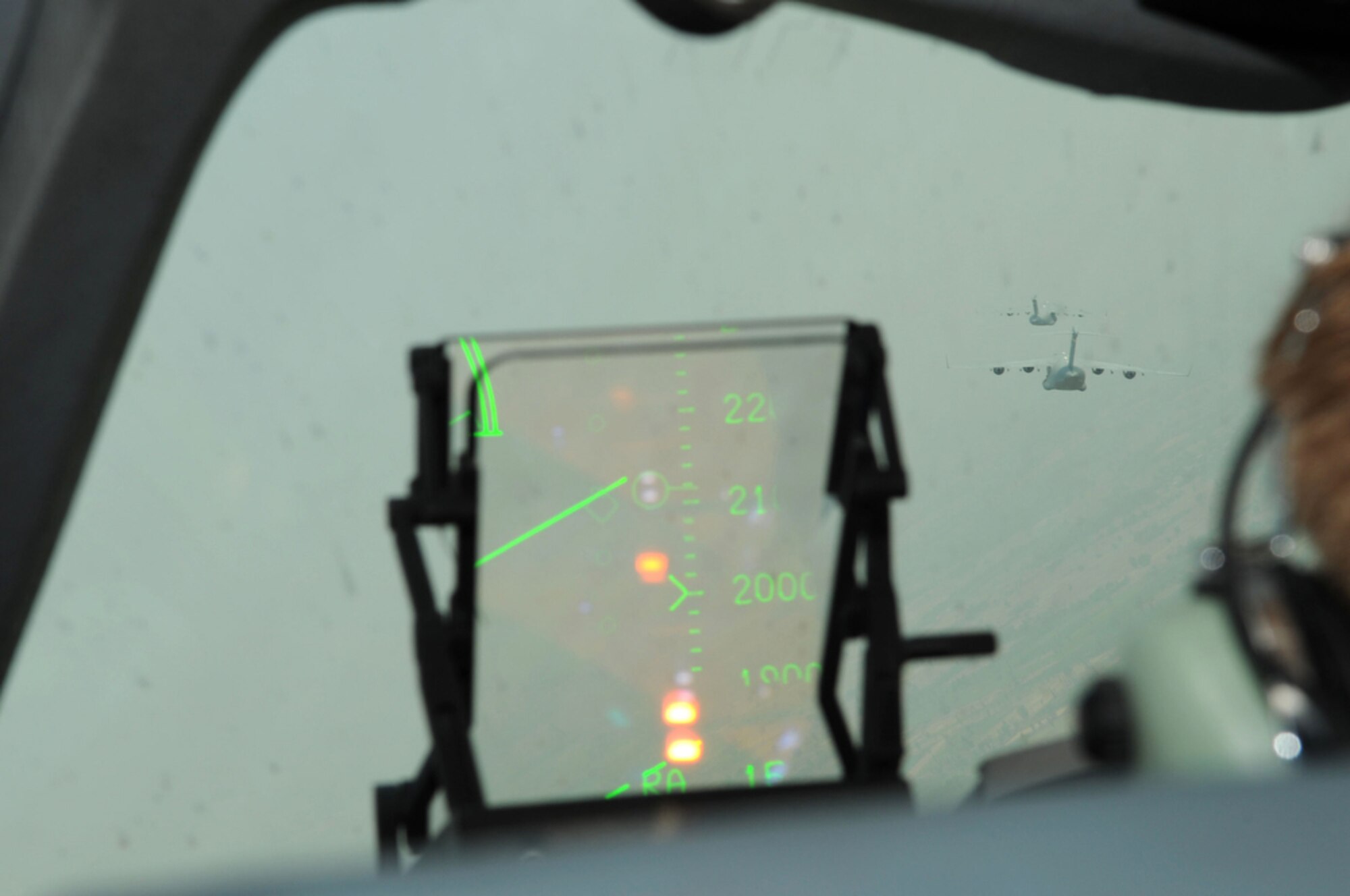 The view from pilot Capt. Joseph Leman's seat in the C-17 Globemaster III cockpit shows two other C-17s participating in a rare three-ship formation as part of Cope Tiger 2010 in Thailand on March 8. Cope Tiger is an annual multilateral exercise conducted in Thailand that includes humanitarian and civic assistance programs. This year's exercise takes place primarily at Udon Thani and Korat Royal Thai Air Force Bases March 1 to 12. (U.S. Air Force photo/Tech. Sgt. Cohen A. Young)