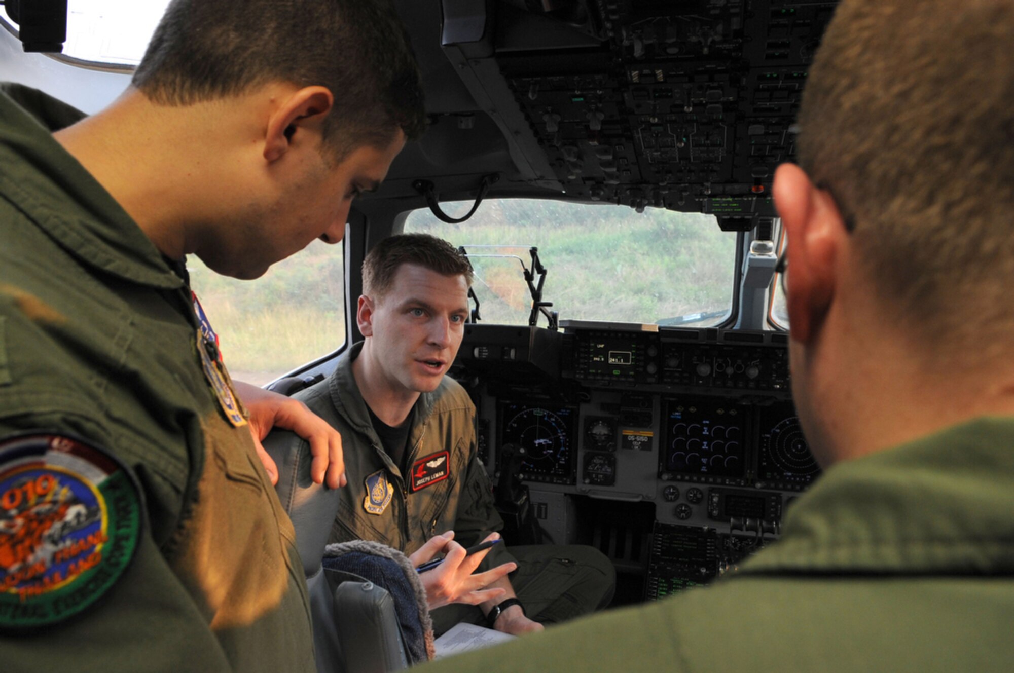 Capt. Joseph Leman (center) reviews the day's mission with fellow crew members before departing Udon Thani Royal Thai Air Force Base, Thailand, for a rare three-ship formation airdrop on March 8. Captain Leman is deployed to Cope Tiger 2010 from the 517th Airlift Squadron at Elmendorf Air Force Base, Alaska. Cope Tiger is an annual multilateral exercise conducted in Thailand that includes humanitarian and civic assistance programs. This year's exercise takes place primarily at Udon Thani and Korat Royal Thai Air Force Bases March 1 to 12. (U.S. Air Force photo/Tech. Sgt. Cohen A. Young)