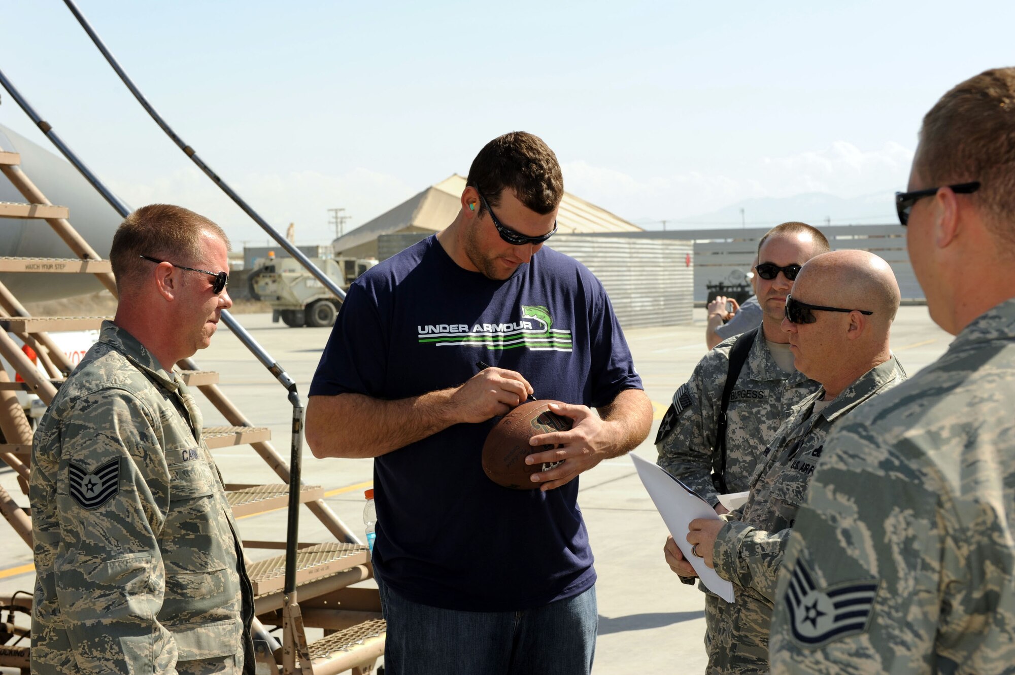 Joe Thomas of the Cleveland Browns signs autographs for Airmen March 5, 2010, during a visit to Bagram Airfield, Afghanistan. (U.S. Air Force photo/Staff Sgt. Richard Williams)