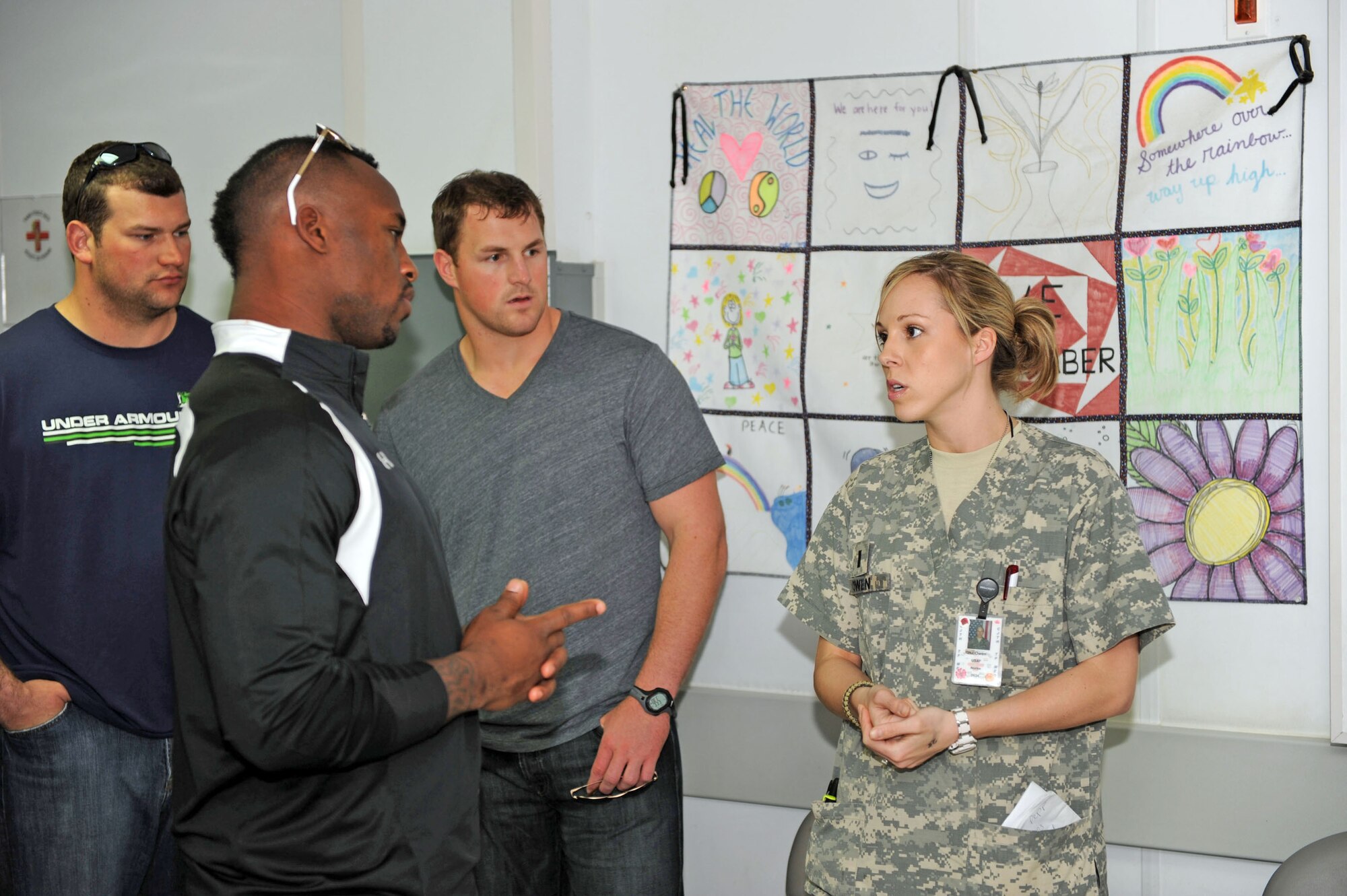 1st Lt. Candice Owen explains basic hospital procedures to National Football League players during a visit to the Craig Joint Theater Hospital March 5, 2010, at Bagram Airfield, Afghanistan. Lieutenant Owen is a 455th Expeditionary Medical Group/Task Force Medical clinical nurse. (U.S. Air Force photo/Staff Sgt. Richard Williams)