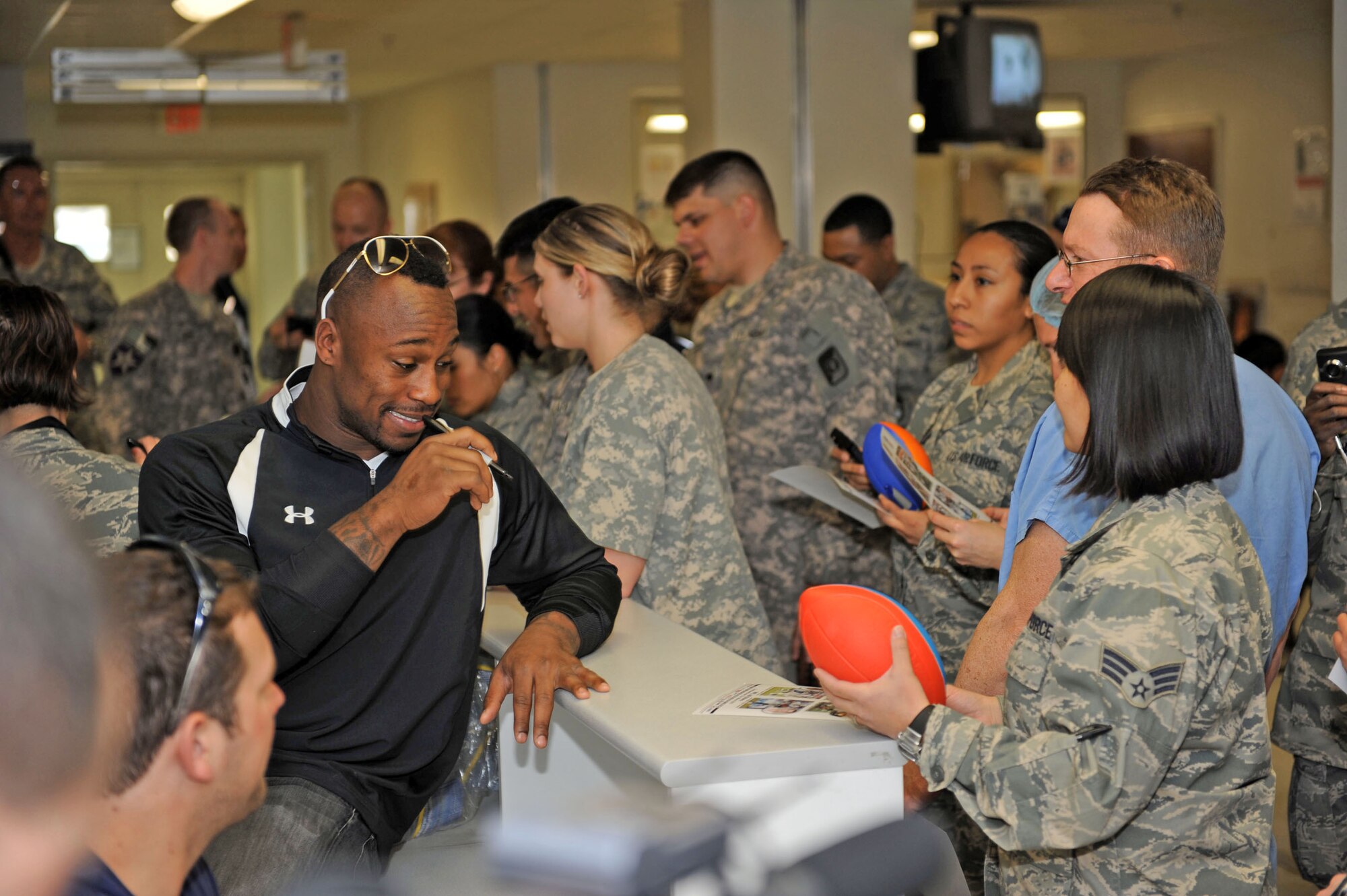 Vernon Davis of the San Francisco 49ers signs autographs for servicemembers March 5, 2010at the Craig Joint Theater Hospital at Bagram Airfield, Afghanistan. (U.S. Air Force photo/Staff Sgt. Richard Williams)