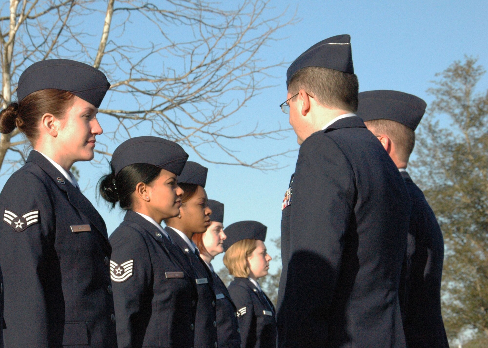Reserve Airmen from the 919th Mission Support Flight stand at attention during a unit training assembly open ranks inspection at Duke Field March 6.   The 919th Special Operations Wing's units periodically hold such inspections to reinforce esprit de corps, uniform wear and appearance standards as well as other time-honored military customs and traditions.  (U.S. Air Force photo/Dan Neely)