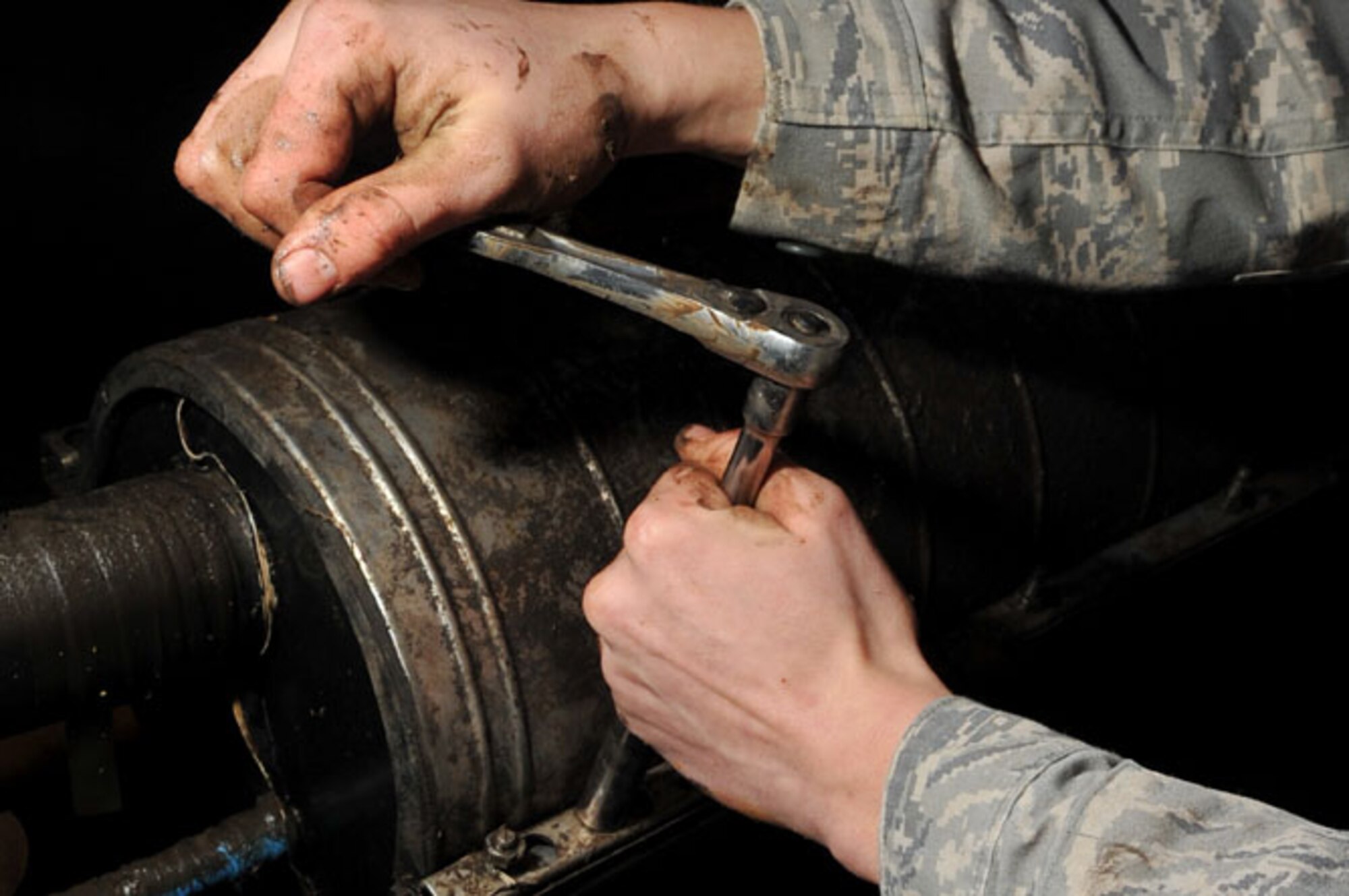 SCOTT AIR FORCE BASE, Ill -- Airman 1st Class Brad Jacobs tightens the nuts on the cover box for the underground 50-pair copper cable March 2, 2010. The 375th Communication Squadron's cable maintenance element or Cable Dawgs are a vital to providing communication capability for Scott Air Force Base. The Cable Dawgs are charged with sustaining the voice systems in support of US Transportation Command, Air Mobility Command headquarters, 18th Air Force, 618th Tanker Airlift Control Center, three flying wings and more than 50 associate units. (U.S. Air Force photo by Senior Airman Teresa M. Jennings)
