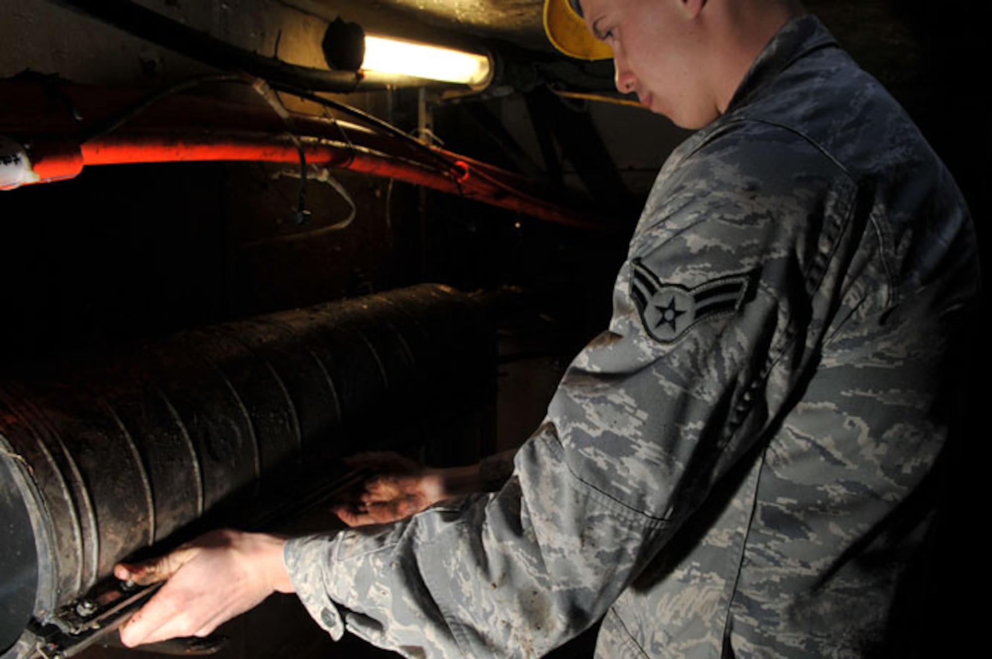 SCOTT AIR FORCE BASE, Ill -- Airman 1st Class Brad Jacobs re-covers the cables after discovering the cables had been wet and were not spliced correctly. The cable maintenance shop will have to return to this manhole to recoat the cables so they will stay dry March 2, 2010. The 375th Communication Squadron's cable maintenance element or Cable Dawgs are a vital to providing communication capability for Scott Air Force Base. The Cable Dawgs are charged with sustaining the voice systems in support of US Transportation Command, Air Mobility Command headquarters, 18th Air Force, 618th Tanker Airlift Control Center, three flying wings and more than 50 associate units.  (U.S. Air Force photo by Senior Airman Teresa M. Jennings)
