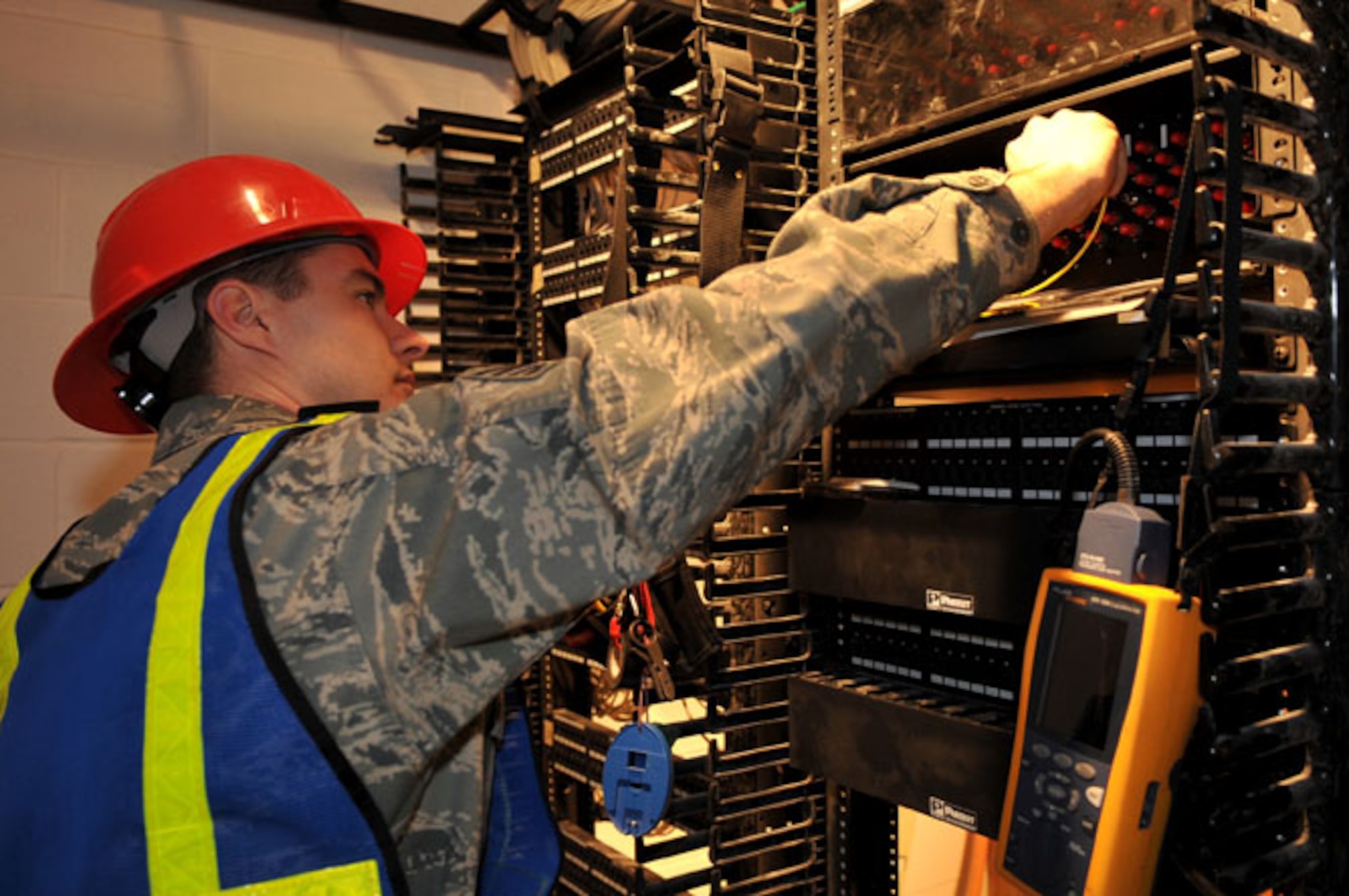 SCOTT AIR FORCE BASE, Ill -- Staff Sgt. Charles Franklin tests new fiber optic cable as part of a quality assurance test in the new 375th Security Forces Squadron building March 2. The 375th Communication Squadron's cable maintenance element or Cable Dawgs are a vital to providing communication capability for Scott Air Force Base. The Cable Dawgs are charged with sustaining the voice systems in support of US Transportation Command, Air Mobility Command headquarters, 18th Air Force, 618th Tanker Airlift Control Center, three flying wings and more than 50 associate units. (U.S. Air Force photo by Senior Airman Teresa M. Jennings)