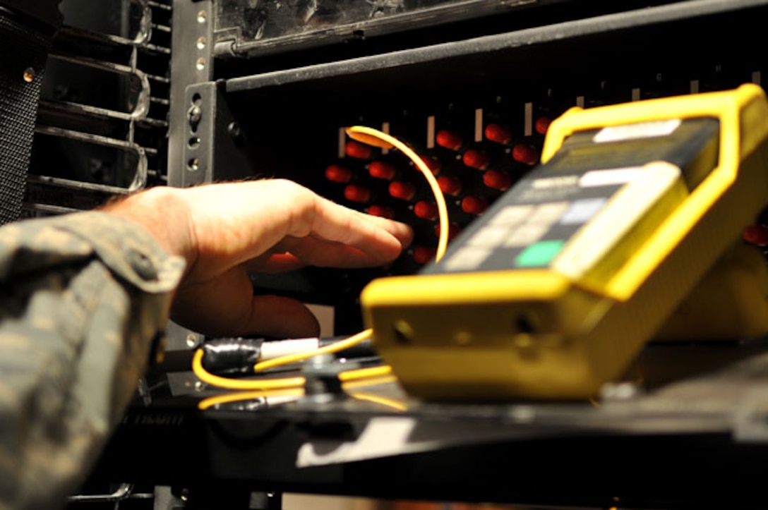 SCOTT AIR FORCE BASE, Ill -- An Airman from the 375th Communications Squadron tests new fiber optic cable with light source and power meter for new 375th Security Force Squadron building March 2, 2010. The 375th Communication Squadron's cable maintenance element or Cable Dawgs are a vital to providing communication capability for Scott Air Force Base. The Cable Dawgs are charged with sustaining the voice systems in support of US Transportation Command, Air Mobility Command headquarters, 18th Air Force, 618th Tanker Airlift Control Center, three flying wings and more than 50 associate units. (U.S. Air Force photo by Senior Airman Teresa M. Jennings)