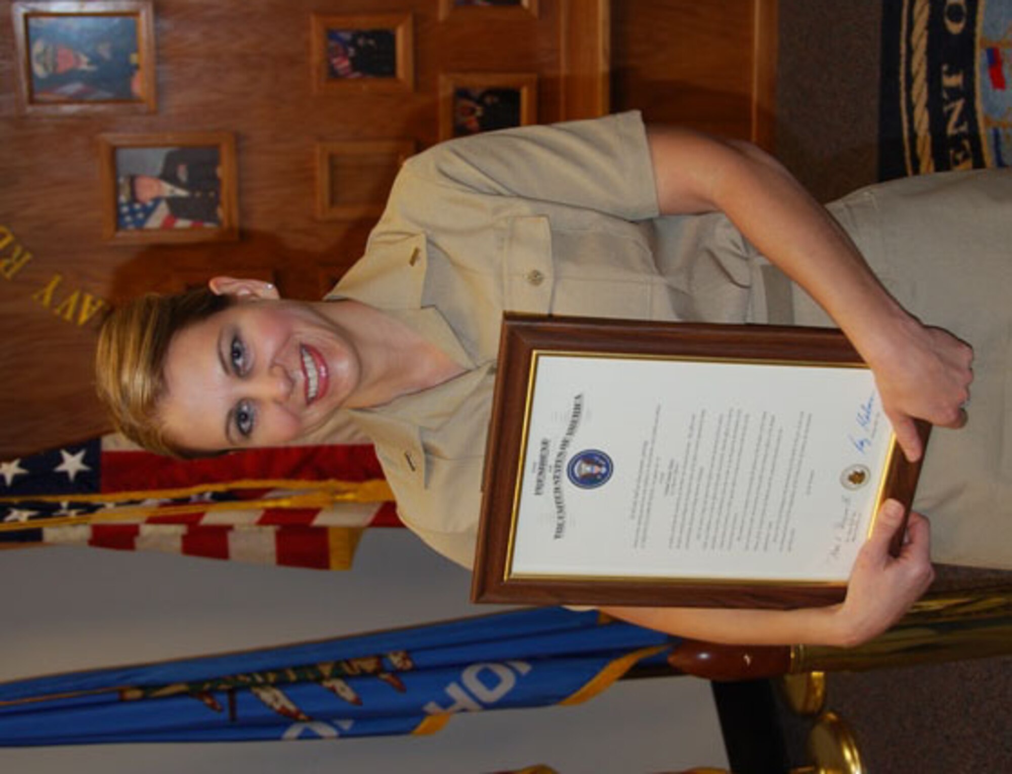 Ensign Kristin Mack, formerly of the 507th Air Refueling Wing's Public Affairs office holds her certificate of comissioning after swearing into the U.S. Navy on December 23.  Although over the Air Force's age limit for commissiong she pursued her dream and discovered she could become commissioned in the U.S. Navy Reserve. The ensign encourages people to pursue their dreams.