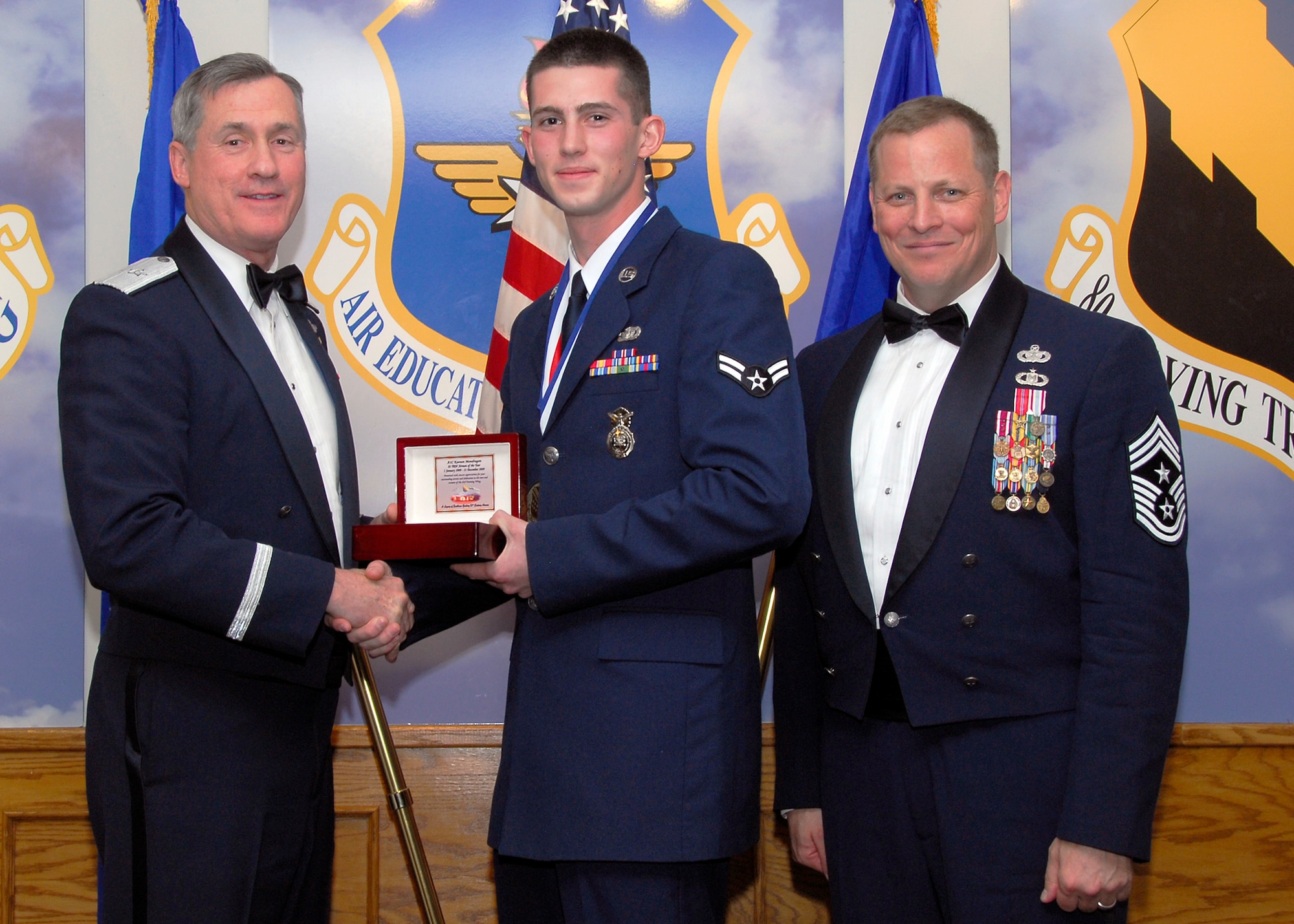 Brig. Gen. O.G. Mannon, 82nd Training Wing commander, presents Airman 1st Class Keenan Mondragon, 82nd Security Forces Squadron, with the Airman of the Year award March 5 during the 2009 82nd TRW Annual Awards banquet. Also pictured is wing Command Chief, Chief Master Sgt. Kenneth Sallinger. (U.S. Air Force photo/Harry Tonemah) 