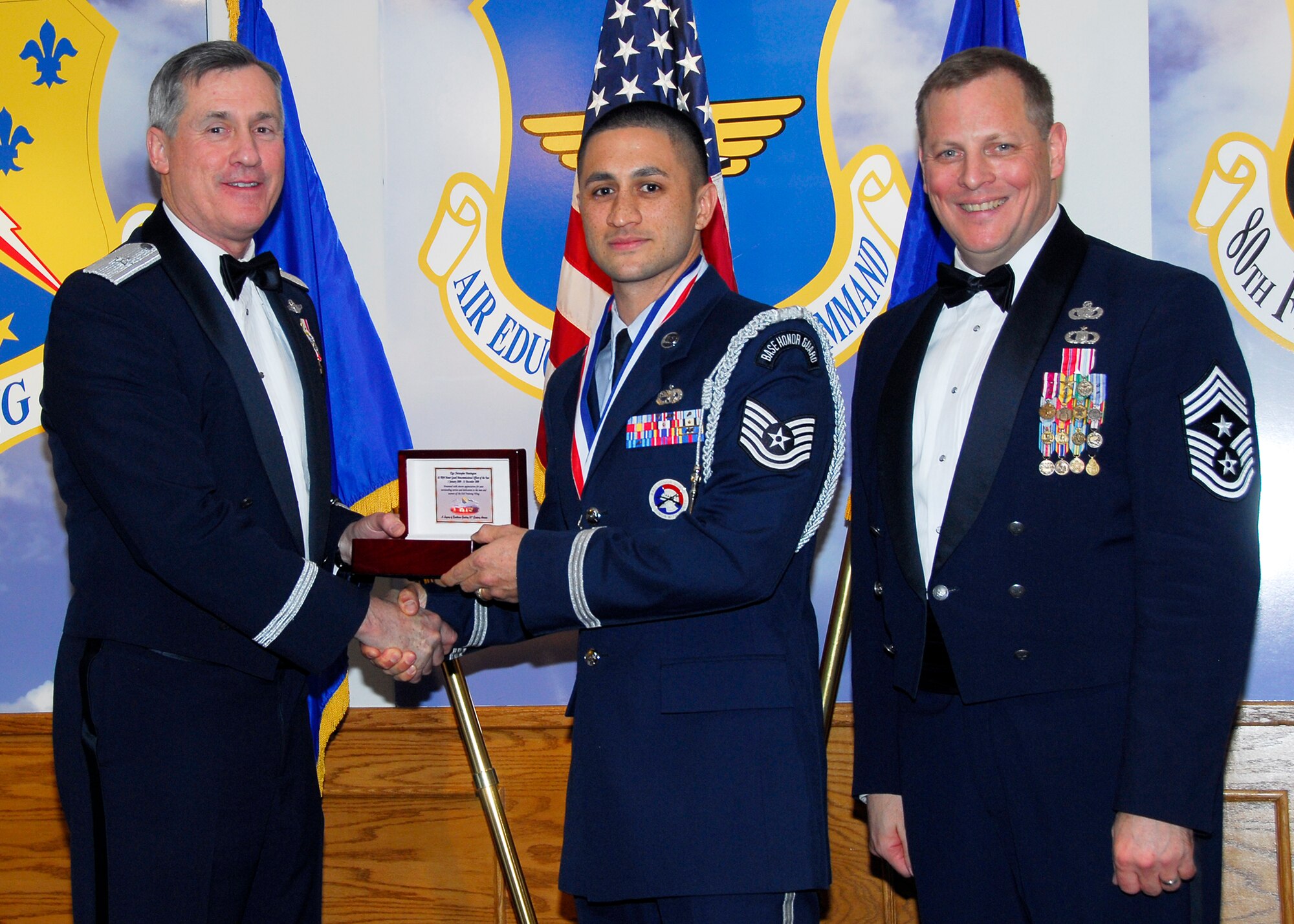 Brig. Gen. O.G. Mannon, 82nd Training Wing commander, presents Tech. Sgt. Christopher Huntington, 361st Training Squadron, with the Honor Guard NCO of the Year award March 5 during the 2009 82nd TRW Annual Awards banquet. Also pictured is wing Command Chief, Chief Master Sgt. Kenneth Sallinger. (U.S. Air Force photo/Harry Tonemah) 