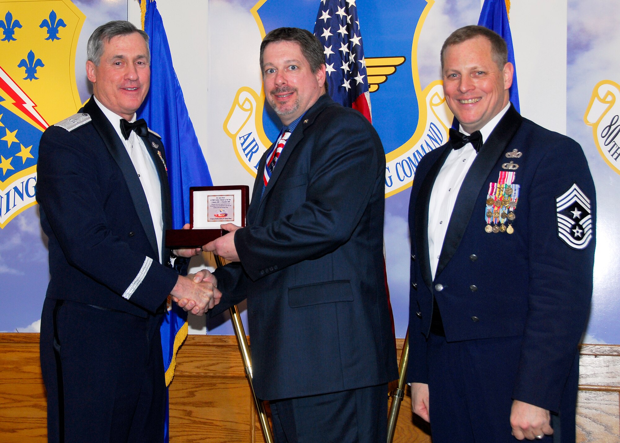 Brig. Gen. O.G. Mannon, 82nd Training Wing commander, presents Jason Durst, 82nd Training Group, with the Civilian Volunteer of the Year award March 5 during the 2009 82nd TRW Annual Awards banquet. Also pictured is wing Command Chief, Chief Master Sgt. Kenneth Sallinger. (U.S. Air Force photo/Harry Tonemah) 