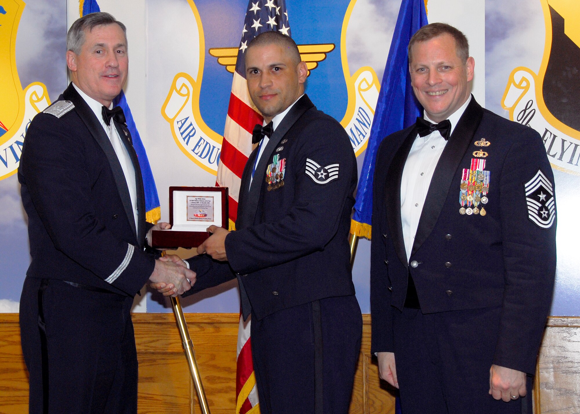 Brig. Gen. O.G. Mannon, 82nd Training Wing commander, presents Staff Sgt. Phillip Baham, 366th Training Squadron, with the Military Volunteer of the Year award, March 5 during the 2009 82nd TRW Annual Awards banquet. Also pictured is wing Command Chief, Chief Master Sgt. Kenneth Sallinger. (U.S. Air Force photo/Harry Tonemah) 