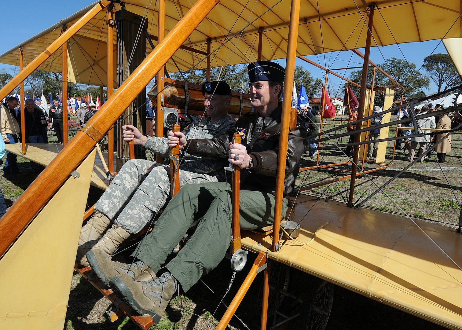 Testing the controls of a reproduction Wright Flyer is U.S. Air Force General Stephen Lorenz, Air Education and Training Command commander. His co-pilot is Army Maj. Gen. Russell Czerw, Fort Sam Houston commander. The two checked out the aircraft during 100th Anniversary of Military Aviation celebration March 2 at Fort Sam Houston, Texas. The first military aviation flight occured on March 2, 1910 on the parade ground at Fort Sam Houston when Army Lt. Benjamin Foulois flew a Wright Flyer. (U.S. Air Force photo by Dave Terry)