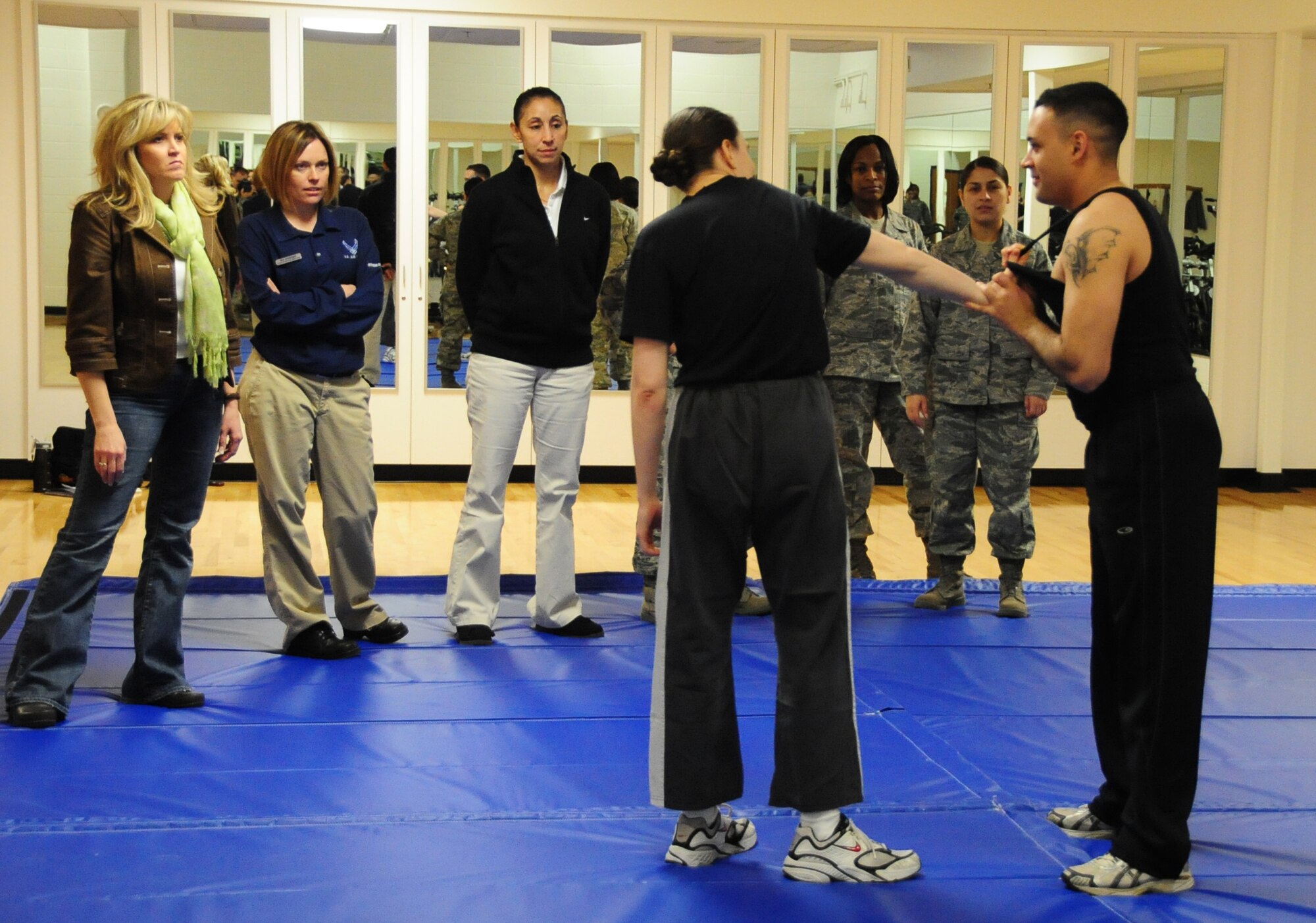 ELLSWORTH AIR FORCE BASE, S.D. -- (Right to left) Airman 1st Class Jarad Denton, 28th Bomb Wing public affairs staff writer and Tech. Sgt. Elizabeth Nagy, 28 BW NCO in charge of equal opportunity, demonstrate defensive moves against an attacker during a self-defense class focused on real-life situations, March 5. The class, which was targeted to women, taught participants how to counter and defend themselves in various situations they may encounter. (U.S. Air Force photo/Airman 1st Class Anthony Sanchelli)
