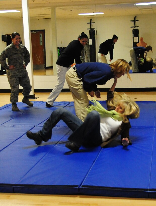 ELLSWORTH AIR FORCE BASE, S.D. -- (Left to right) Carey Karger, 28th Force Support Squadron fitness center director, throws Michelle Rogers using a "Hip Flip" maneuver during a self-defense class focused on real-life situations, March 5.  The class, which was targeted to women, taught participants how to counter and defend themselves in various situations they may encounter. (U.S. Air Force photo/Airman 1st Class Anthony Sanchelli)
