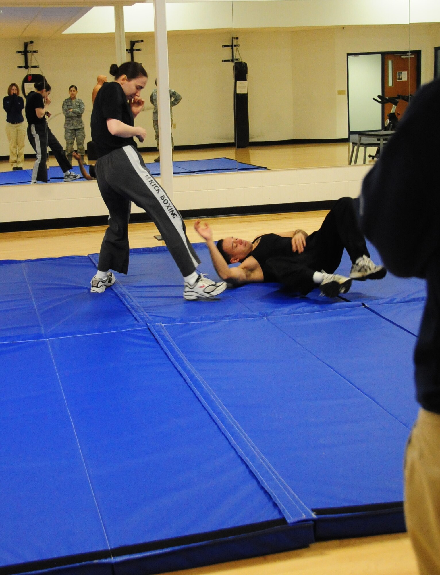 ELLSWORTH AIR FORCE BASE, S.D. -- Tech. Sgt. Elizabeth Nagy, 28th Bomb Wing NCO in charge of equal opportunity, throws Airman 1st Class Jarad Denton, 28 BW public affairs staff writer by using a "Hip Flip" maneuver during a self-defense class focused on real-life situations, March 5.  The class, which was targeted to women, taught participants how to counter and defend themselves in various situations they may encounter. (U.S. Air Force photo/Airman 1st Class Anthony Sanchelli)
