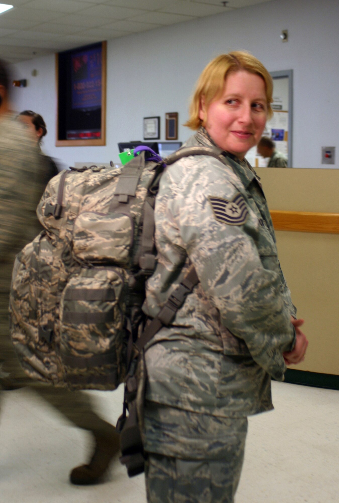Tech. Sgt. Jean Brooks, medical technician, 59th Inpatient Operations Group, Wilford Hall Medical Center, carries a 70-pound backpack, as she prepares to board a C-17 Globemaster enroute to Angol, Chile to aid victims of an 8.8 magniture earthquake Feb. 27. Sgt. Brooks is one of 10 Airmen from WHMC that joins the Air Force Expeditionary Medical Support. EMEDS is a rapidly deployable medical team equipped and staffed to provide surgical, primary care and other medical services in field conditions. The team departed from Lackland Air Force Base, Texas March 8, and includes 84 Airmen from 13 bases across the U.S. (U.S Air Forc photo/Linda Frost)