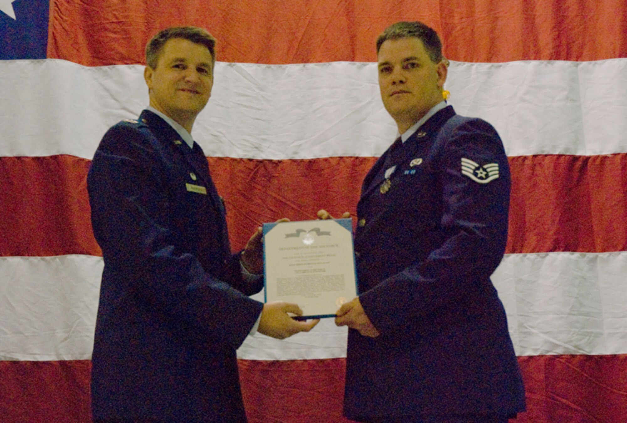 Colonel Heath J. Nuckolls, commander, 94th Airlift Wing, presents the Air Force Achievement Medal to Staff Sgt. Brian D. Huelskamp, civil engineer, 94th Civil Engineering Squadron, for outstanding achievement Jul. 1 thru Aug. 15, 2008 at the wing commander’s call March 6. (U.S. Air Force photo/Staff Sgt. Samuel H. Hunt)