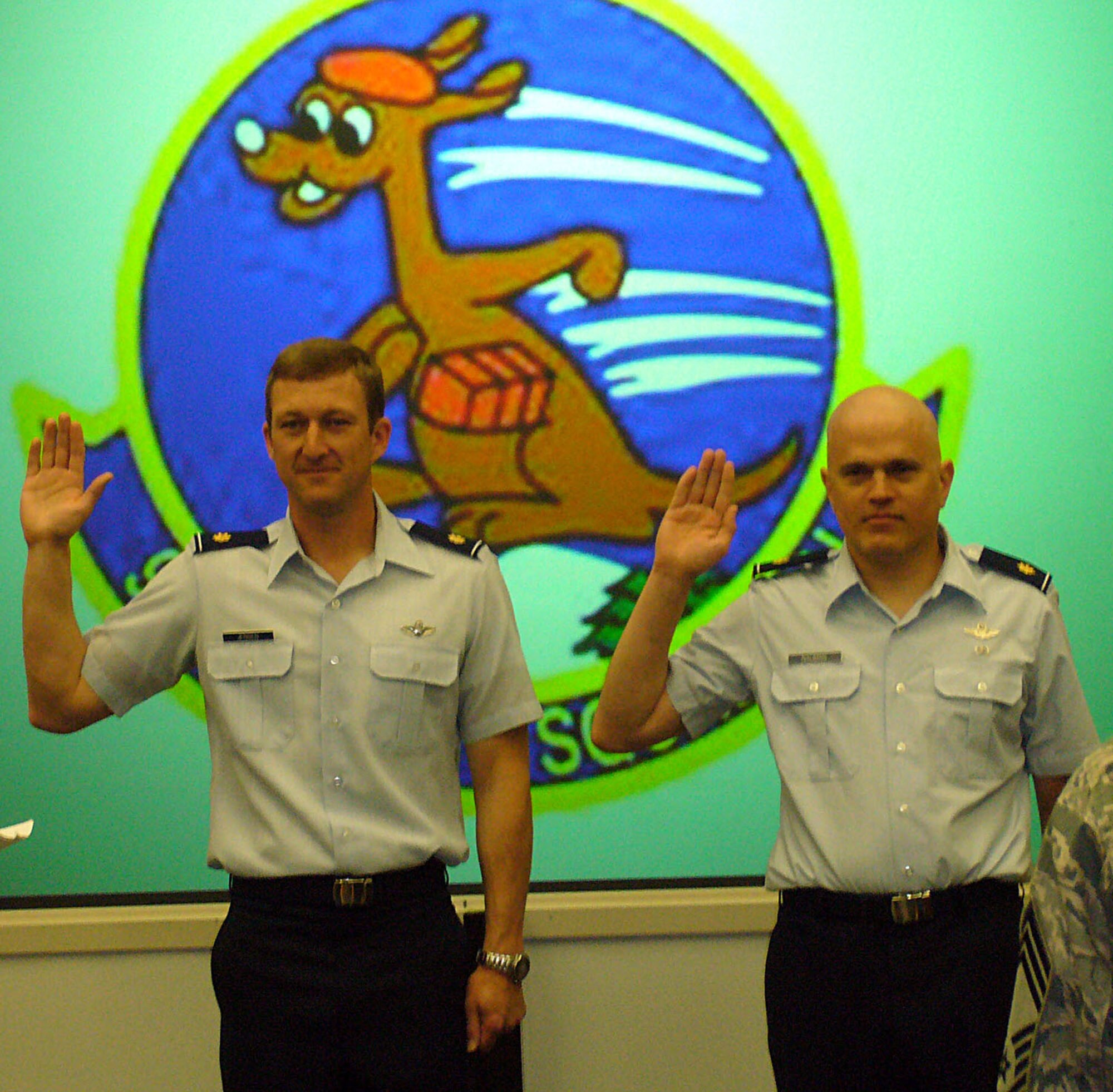 JOINT BASE LEWIS-MCCHORD, Wash., - In May 2009 Maj. Joe Nauman, right, takes the oath of office during his pin on ceremony when he was promoted to lieutenant colonel.  Colonel Nauman, a Reservist with the 97th Airlift Squadron, JBLM McChord Field, recently visited the doctor in New Zealand whom he credits with initiating the discovery of his non-Hodgkin's lymphoma. Chemotherapy and radiation may have resulted in hair loss, but ultimately resulted in his illness being sent into remission. (Courtesy photo)