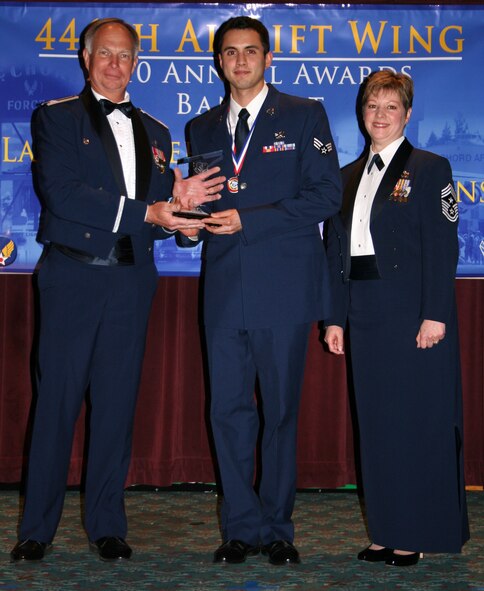 JOINT BASE LEWIS-MCCHORD, Wash.- Senior Airman Christopher Sears, center, 446th Maintenance Squadron here, accepts the 2009 446th Airlift Wing Airman of the Year Award with 446th AW commander, Col. William Flanigan, left, and 446th AW command chief, Chief Master Sgt. Gloria Bennett at the 446th AW Annual Awards Banquet at the McChord Consolidated Clubs here March 6. Colonel Flanigan and Chief Bennett presented the award. Airman Sears was also the 2009 Airmen of the Quarter for the second quarter. (U.S. Air Force photo/Tech. Sgt. Heather Normand)