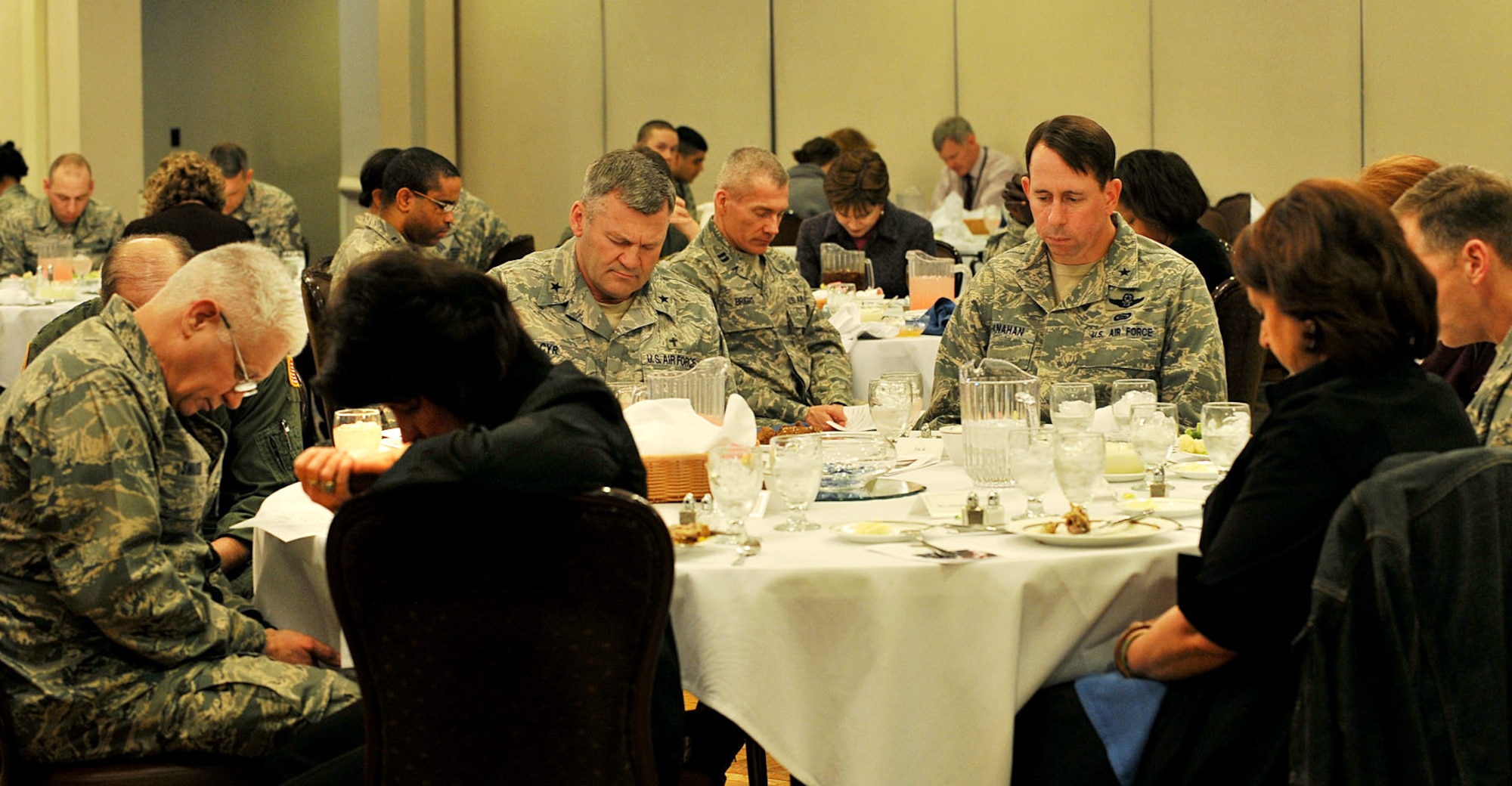 OFFUTT AIR FROCE BASE, Neb. -- Brig. Gen. John N.T. Shanahan, 55th Wing commander, and other members of Team Offutt pray for deployed servicemembers and their families during the National Prayer Luncheon at the Patriot Club here March 3. U.S. Air Force photo by Charles Haymond