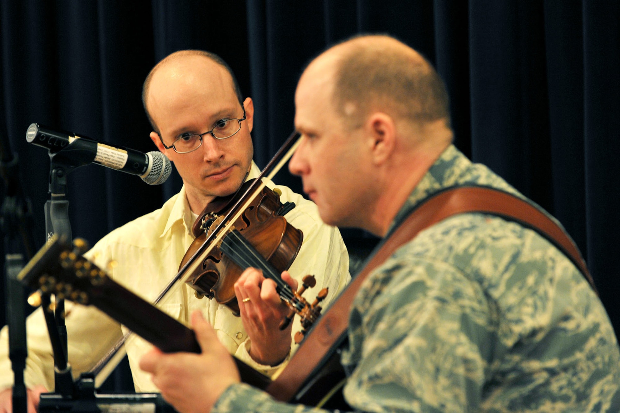 OFFUTT AIR FORCE BASE, Neb. -- Thad Miller, a local musician and Chaplain (Capt.) Shannon Workman, 55th Wing chaplain, entertain the crowd during the National Prayer Luncheon at the Patriot Club here March 3. Throughout the event many members of Team Offutt representing different faiths and backgrounds came together to pray for the warriors fighting for America, as well as their families. U.S. Air Force photo by Charles Haymond