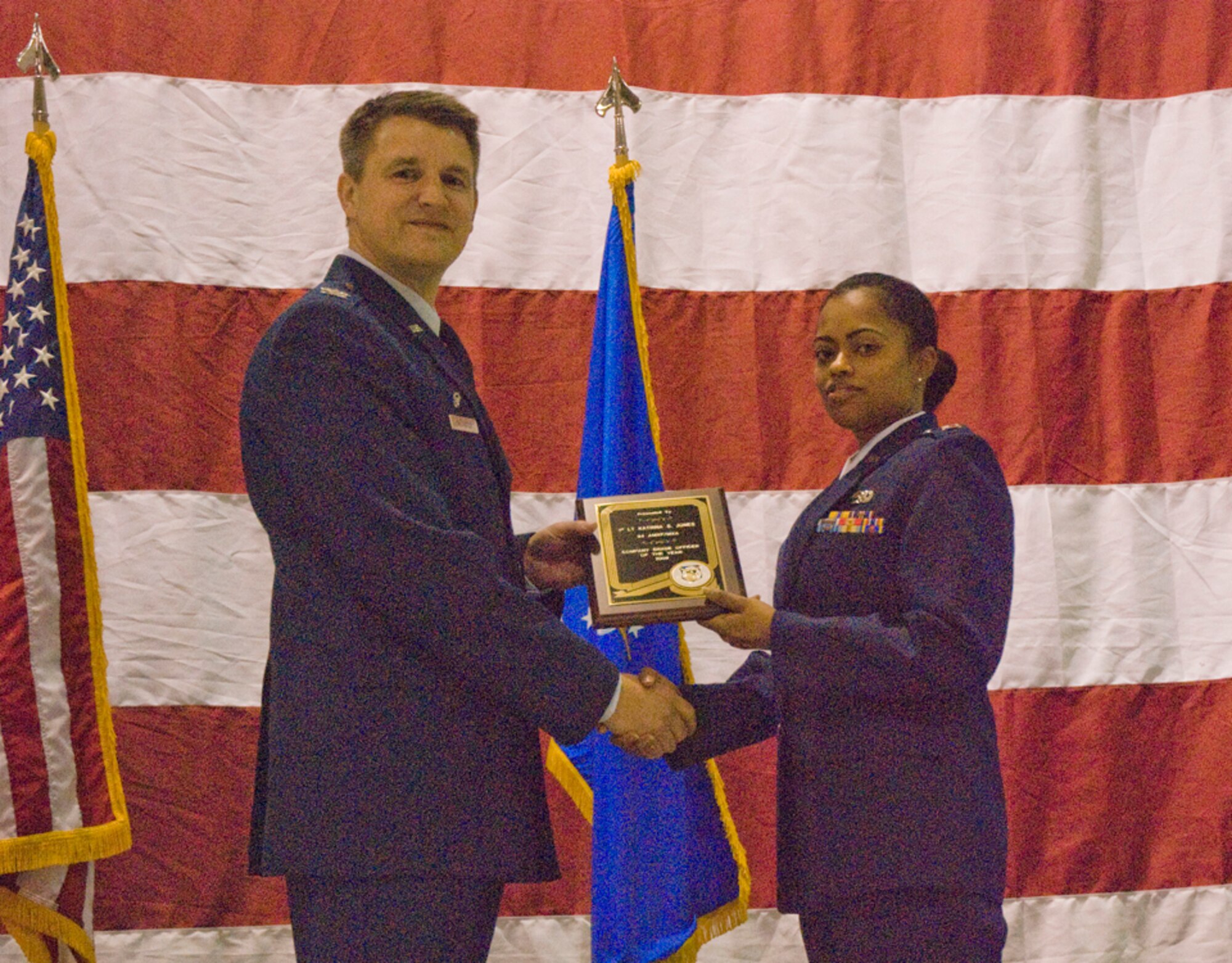 Colonel Heath J. Nuckolls, commander, 94th Airlift Wing, presents the Company Grade Officer of the Year award to 1st Lt Katrina Jones, operations officer, 94th Maintenance Flight at the wing commander’s call March 6. (U.S. Air Force photo/Staff Sgt. Samuel H. Hunt)