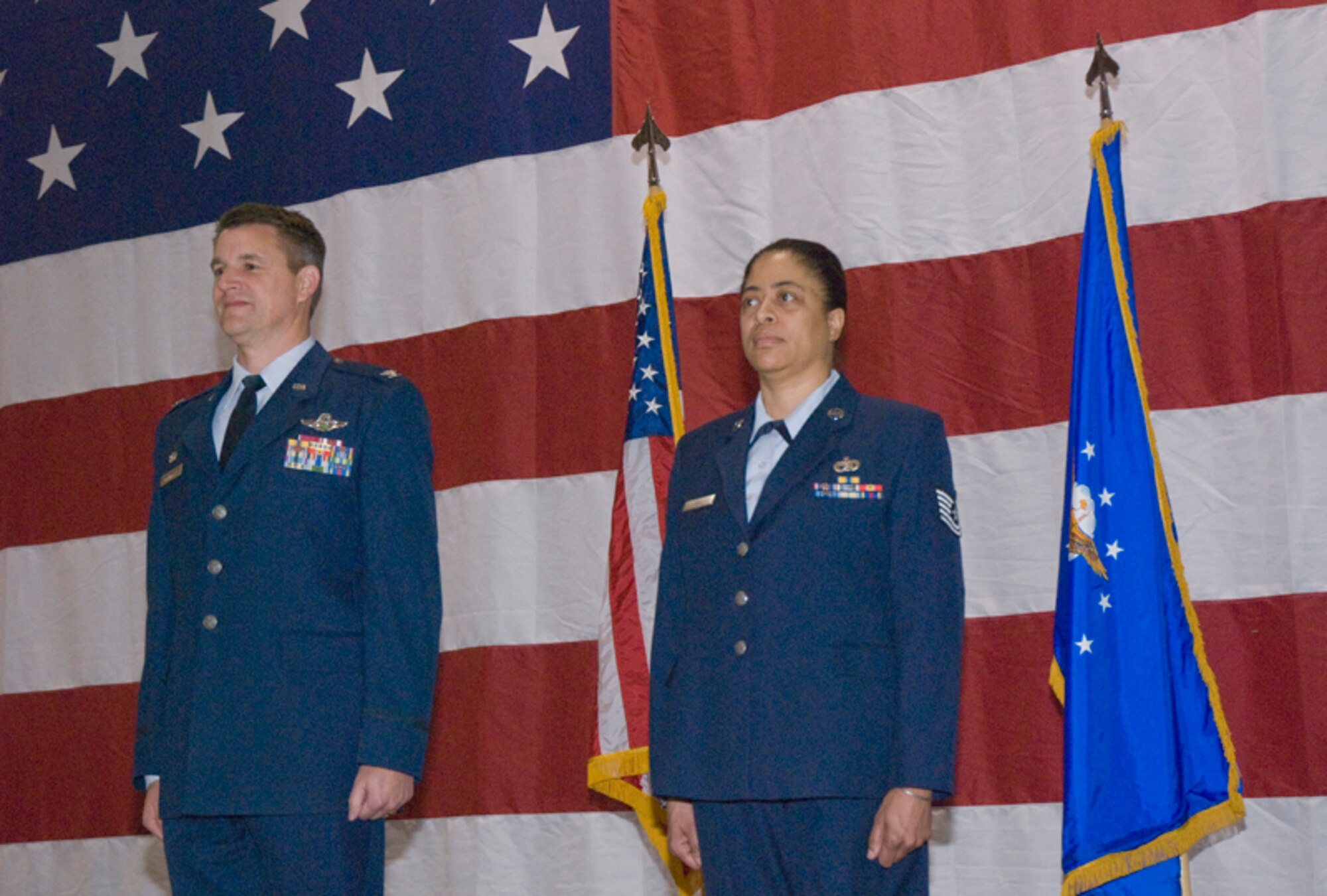 Colonel Heath J. Nuckolls, commander, 94th Airlift Wing, presents the Air Force Commendation Medal to Technical Sergeant Sharon L. Veal, air terminal operations center supervisor, 80th Aerial Port Squadron, for meritorious service 01 Sept. 1, 2005 to December 1, 2008 at the wing commander’s call March 6. (U.S. Air Force photo/Staff Sgt. Samuel H. Hunt)