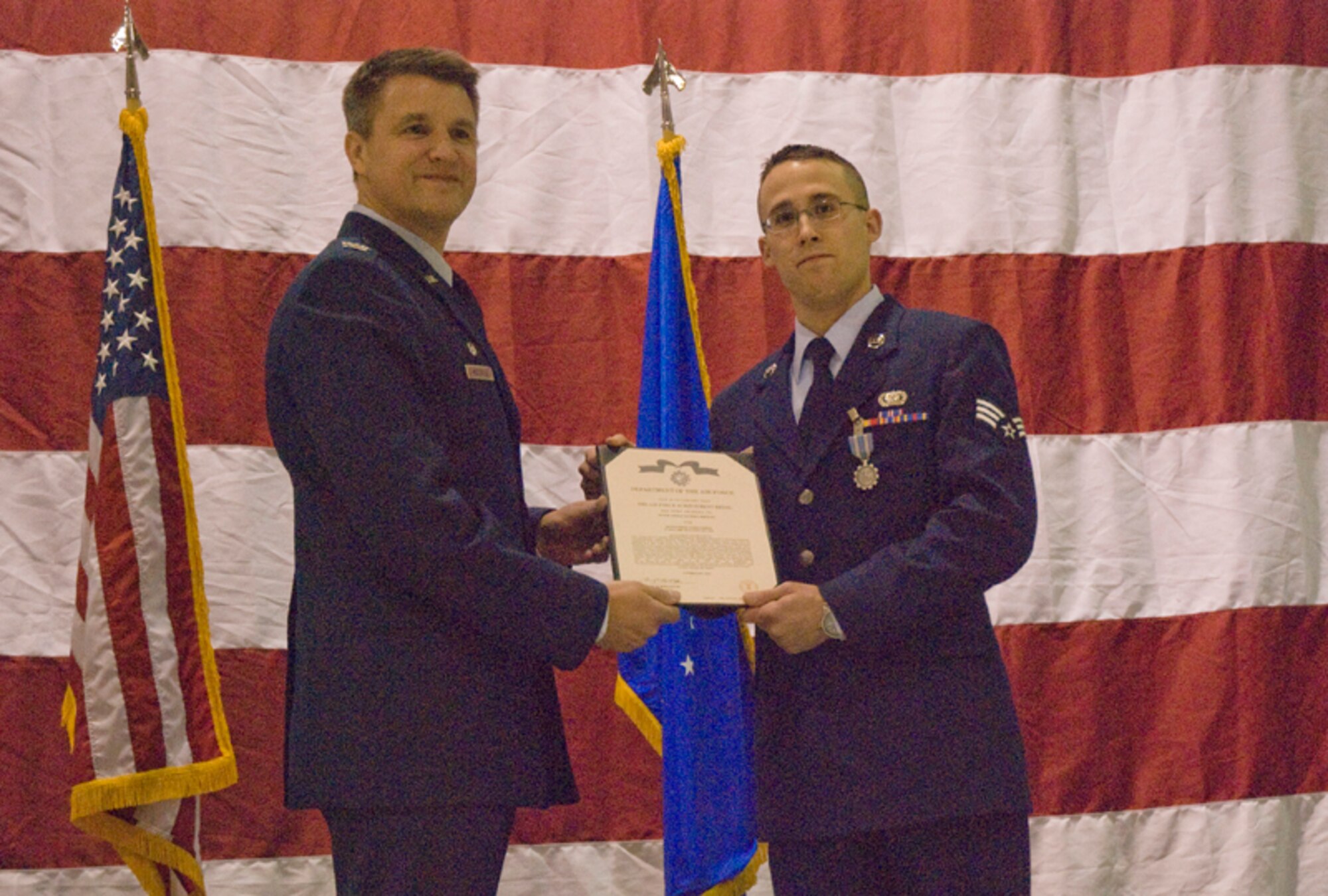 Colonel Heath J. Nuckolls, commander, 94th Airlift Wing, presents the Air Force Achievement Medal to Senior Airman Xavier J. Jernigan for Outstanding Achievement during his 17 July to 14 Jan. service to the 332nd Air Expeditionary Wing, Joint Base Balad, Iraq at the wing commander’s call March 6. (U.S. Air Force photo/Staff Sgt. Samuel H. Hunt)
