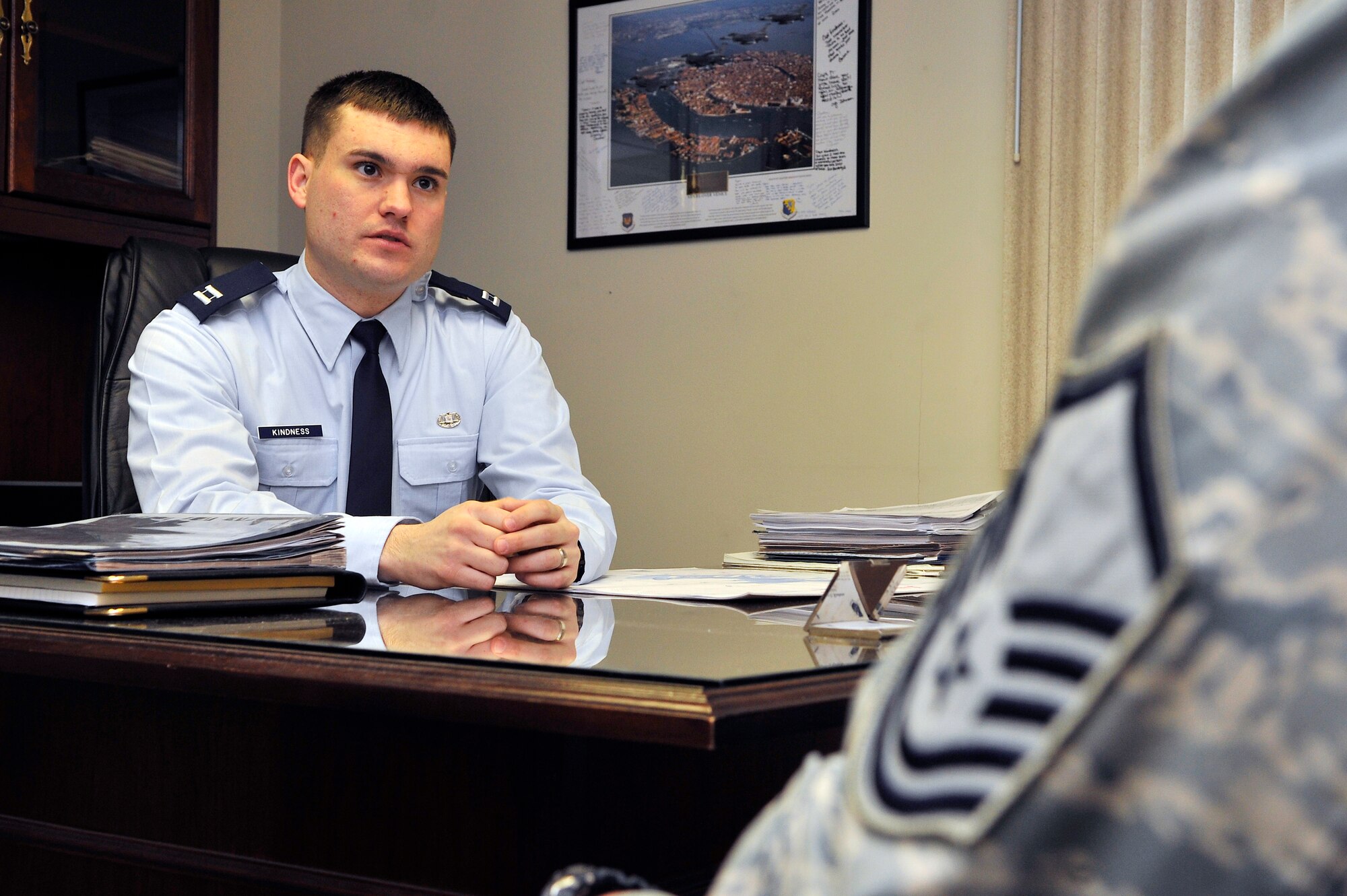 Capt. Tyson Kindness assists a client at the Area Defense Counsel Mar. 1, 2010, Eielson Air Force Base, Alaska. The ADC helps Airmen facing adverse action and criminal proceedings. Captain Kindness is one of Eielson's legal defense experts. (U.S. Air Force photo/Staff Sgt. Christopher Boitz)