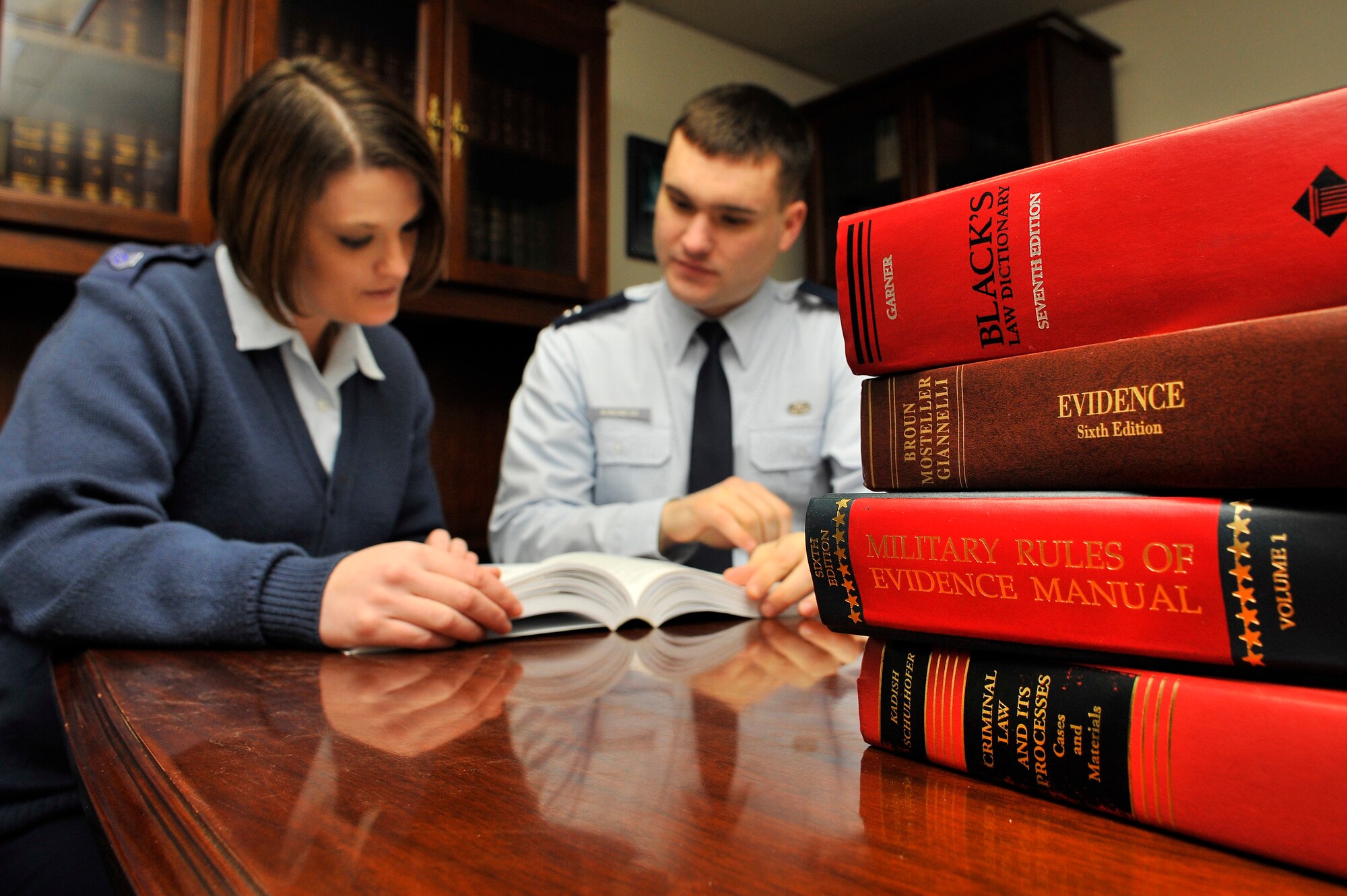 Staff Sgt. Nikki Fratzke and Capt. Tyson Kindness review the Uniform Code of Military Justice at the Area Defense Counsel Mar. 1, 2010, Eielson Air Force Base, Alaska. The ADC represents Airmen who are facing legal proceedings and need assistance. Captain Kindness and Sergeant Fratzke are Eielson's legal defense experts. (U.S. Air Force photo/Staff Sgt. Christopher Boitz)