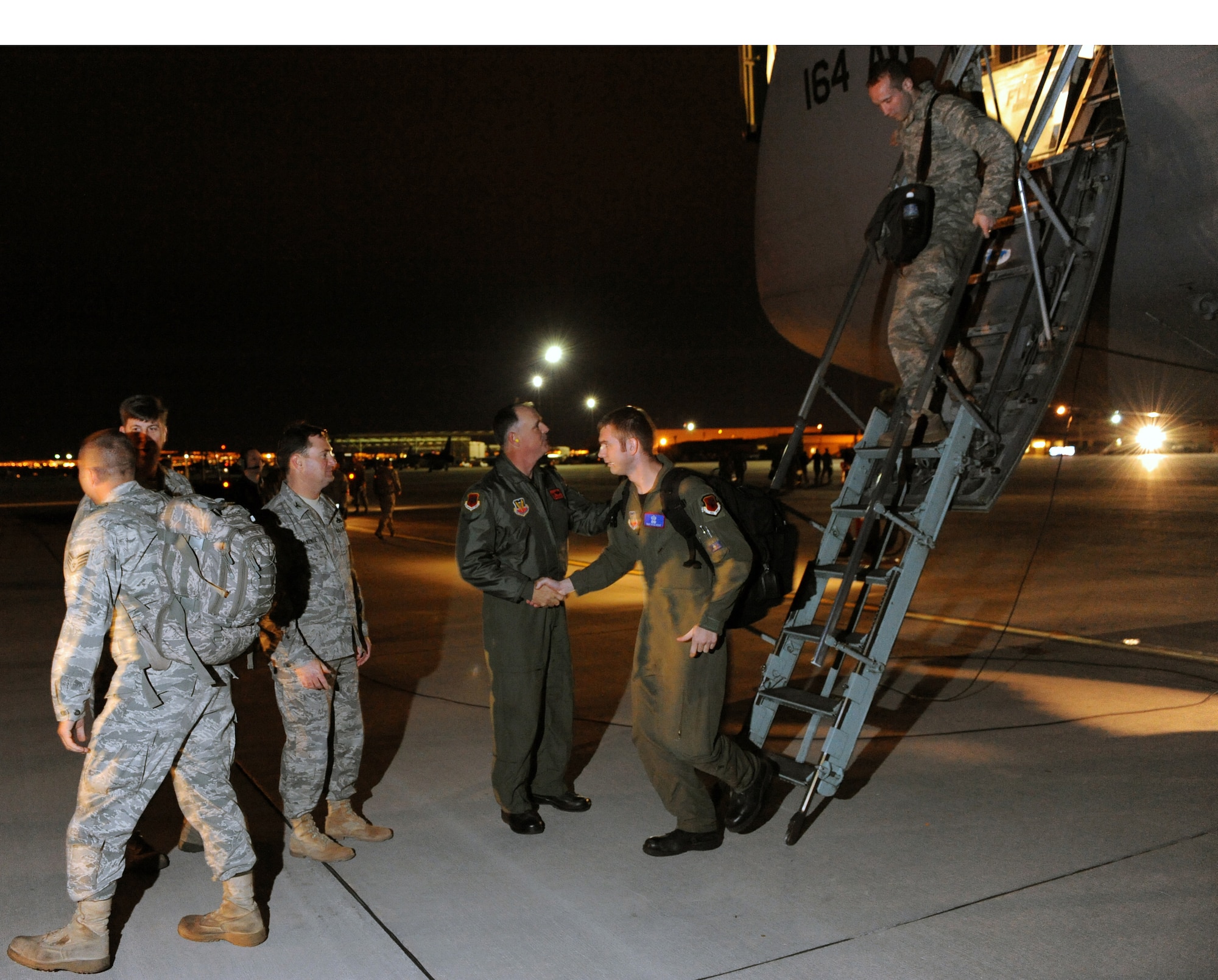 NELLIS AIR FORCE BASE, Nev. --  Colonel William Brandt, 432d Operations Group commander, and Colonel James McKenzie, 432d Maintenance Group commander, welcome Airmen on the flightline at Nellis AFB March 5 as they returned home from supporting Operation United Response. Airmen assigned to the 432d Wing returned home from the first ever humanitarian deployment of an RQ-1 Predator. (U.S. Air Force photo by Tech. Sgt. Michael R. Holzworth)